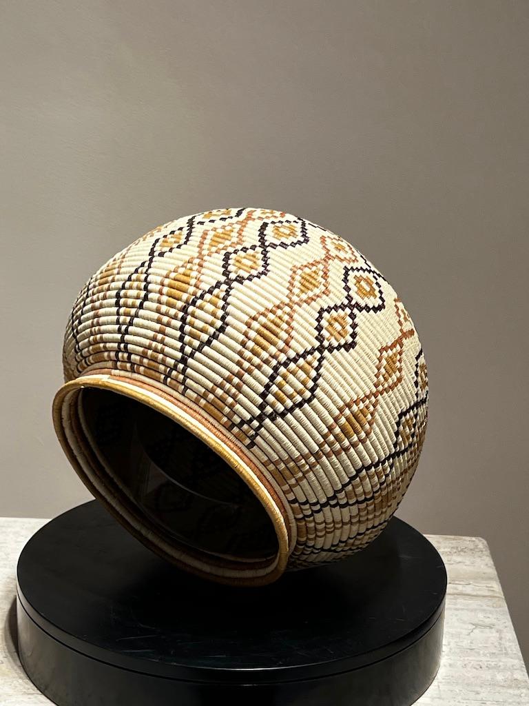 Geometric Basket, tan, white, black, Wounaan Tribe, Panama, rainforest, diamonds

Palm fiber and vegetal dyes

The baskets are made by the Wounaan and Embera Indians from the Darien Rainforest in Panama.  The Wounaan believe they emerged from the