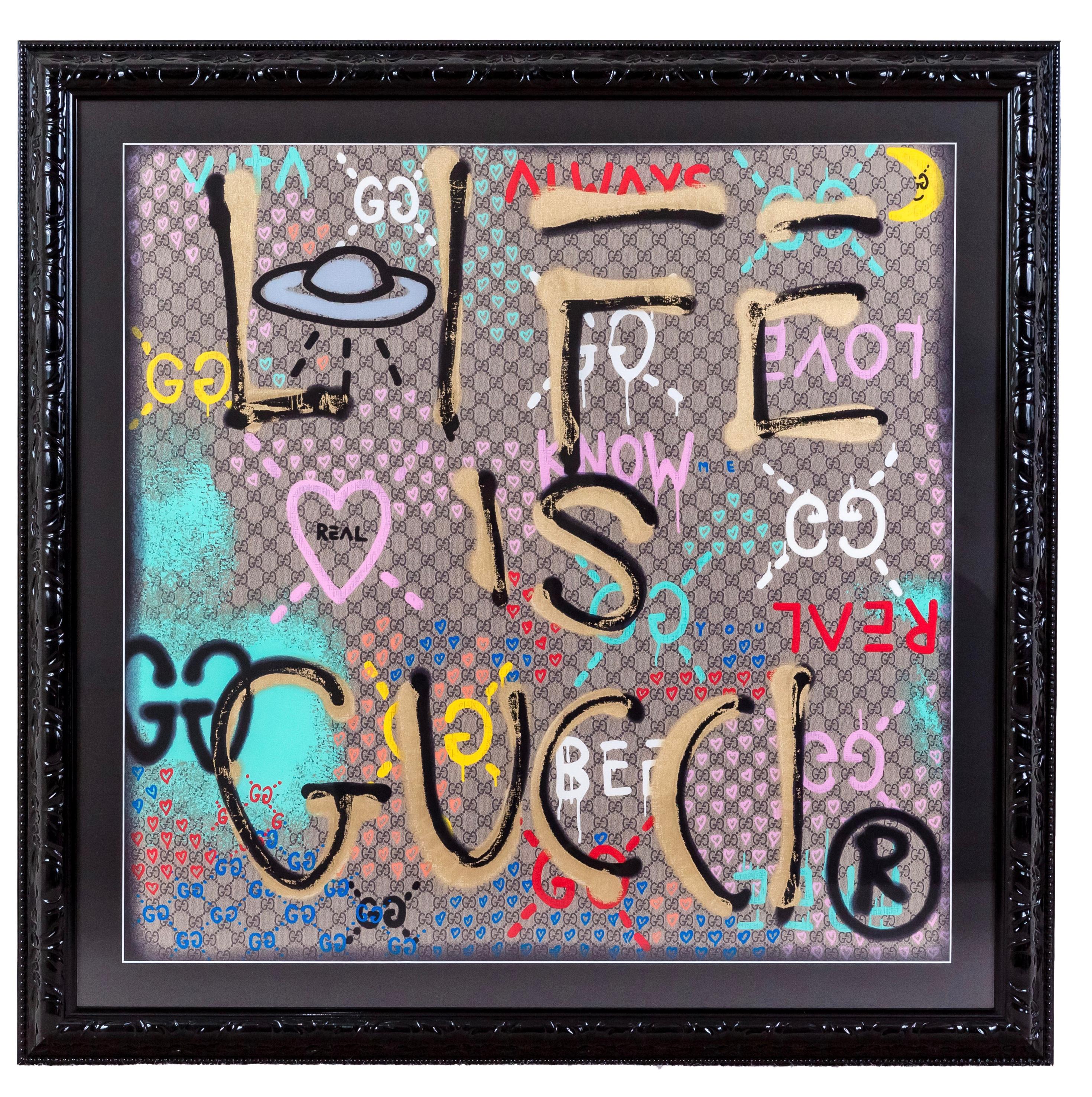 Gucci - Life is Gucci logo silk scarf in bespoke frame

Gucci's special range of accessories and ready-to-wear that feature their signature phrases. The ironic and witty handwritten aphorisms appear over the Gucci vintage logo This silk scarf is