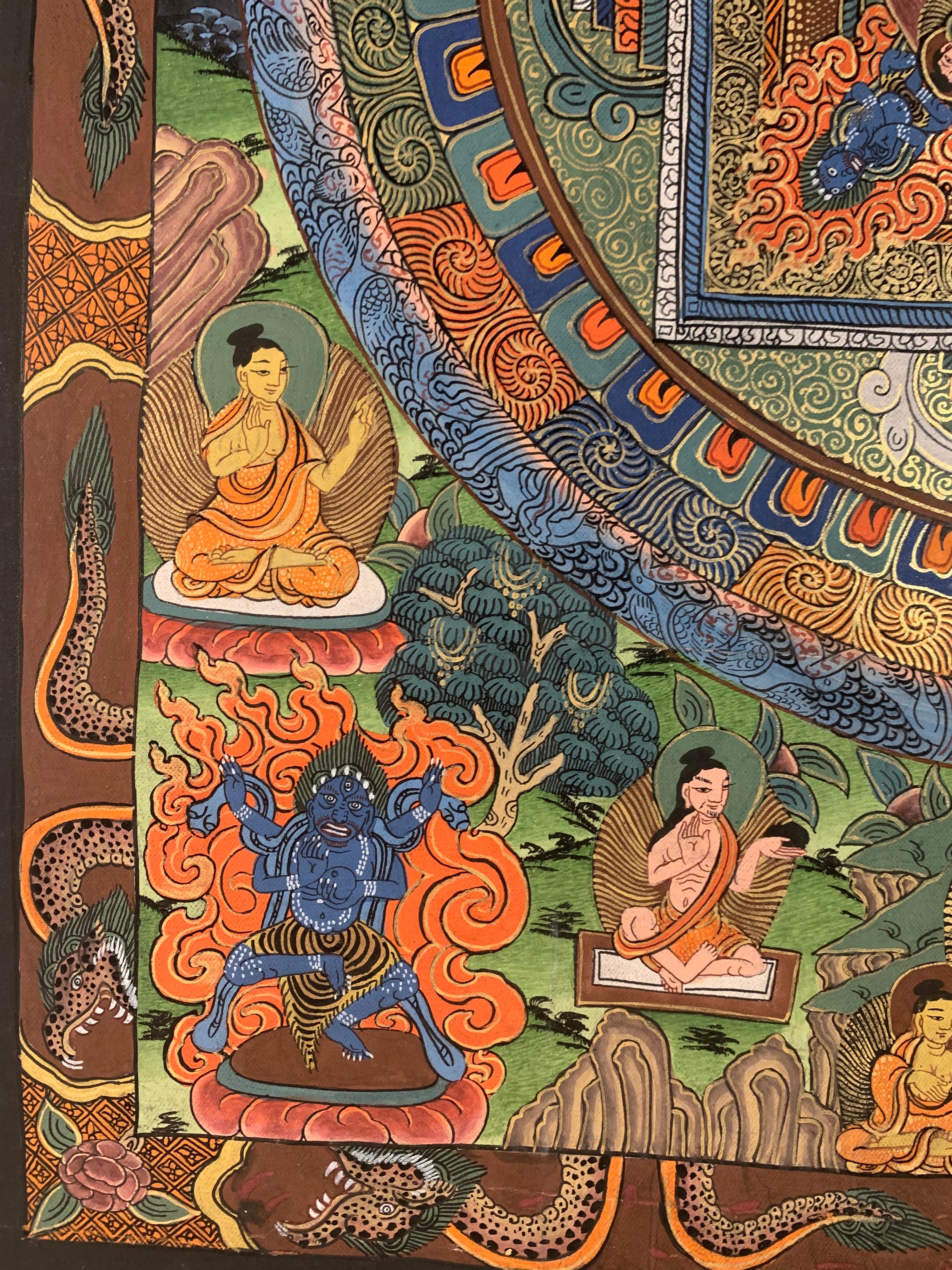 This mandala thangka is hand painted on canvas with 24k gold. Different hues of Blue,Orange and brown colors blend seamlessly with the shimmering of real gold.
The measurement of Canvas is 22