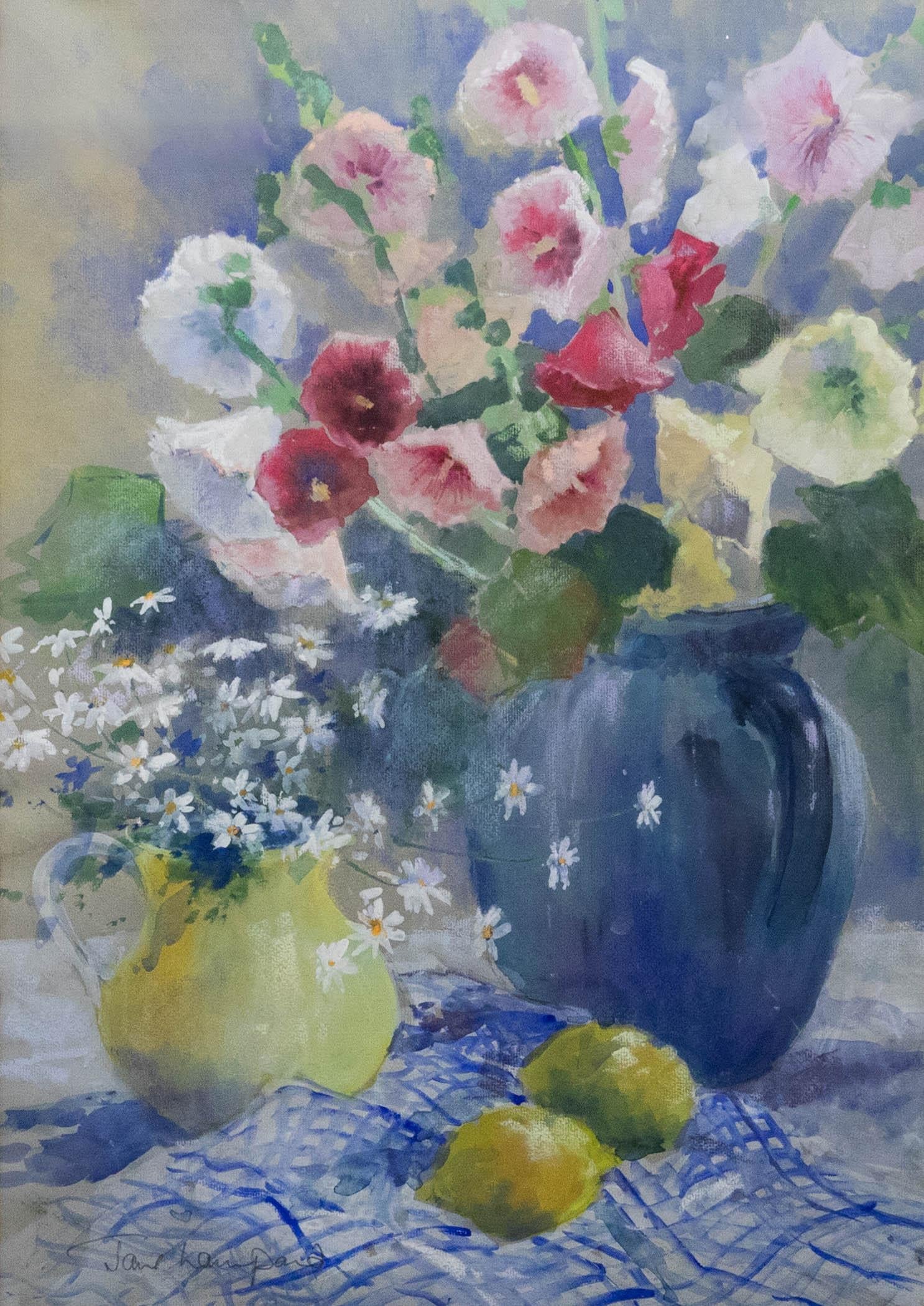 A colourful study of hollyhocks and daisies, placed alongside two lemons on gingham. Well presented in a large wooden frame with double card mount. Signed in graphite to the lower left. On paper. 