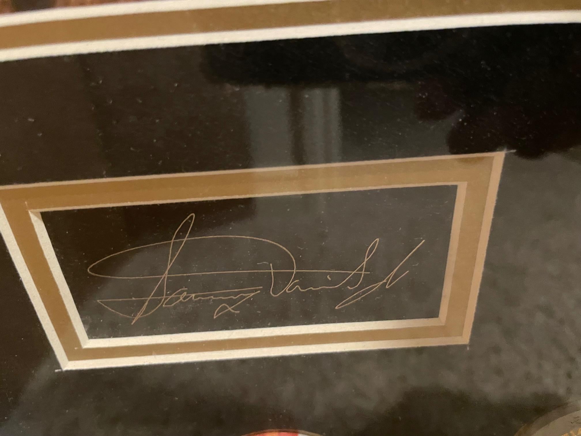 Rat Pack enthusiasts will love this piece!  It includes their signatures, photographs from the Sands Hotel in Vegas, copies of their signatures and actual chips from the casinos that no longer stand along the Vegas Strip.

It is in excellent