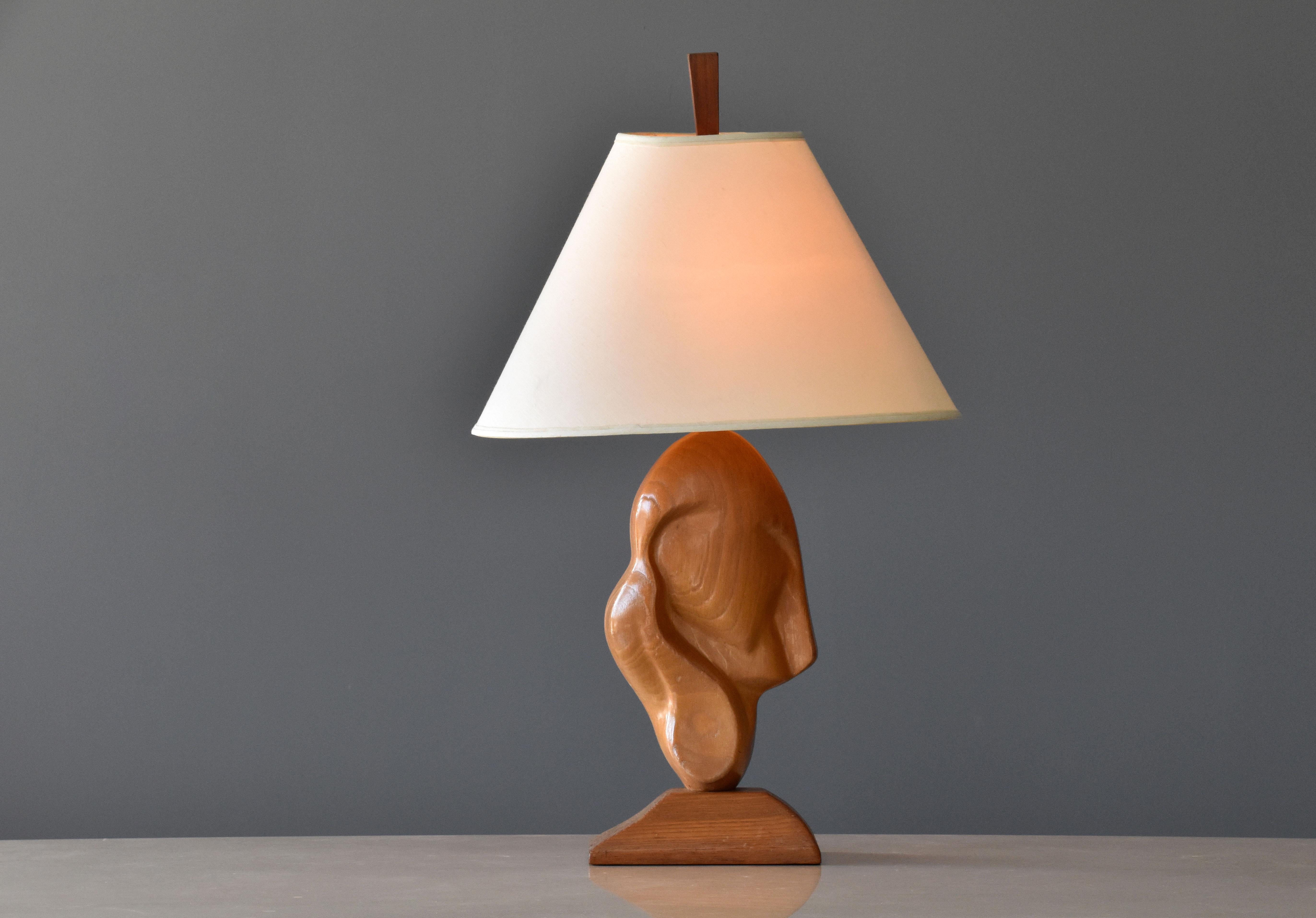 A sculptural and organic / biomorphic table lamp in carved oak, in abstract form, by an unknown designer. Bears its original lampshade and finial. 

Other American designers include George Nakashima, Phillip Lloyd Powell, J.B. Blunk, Paul Frankl,