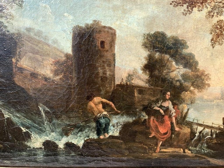 Venetian painter of the 18th century - Arcadian landscape with fishermen and medieval tower. 

34 x 63 cm without frame, 45 x 74 cm with frame. 

Oil on canvas, in an 18th century gilded wooden frame. 

- The author is inspired by the compositional