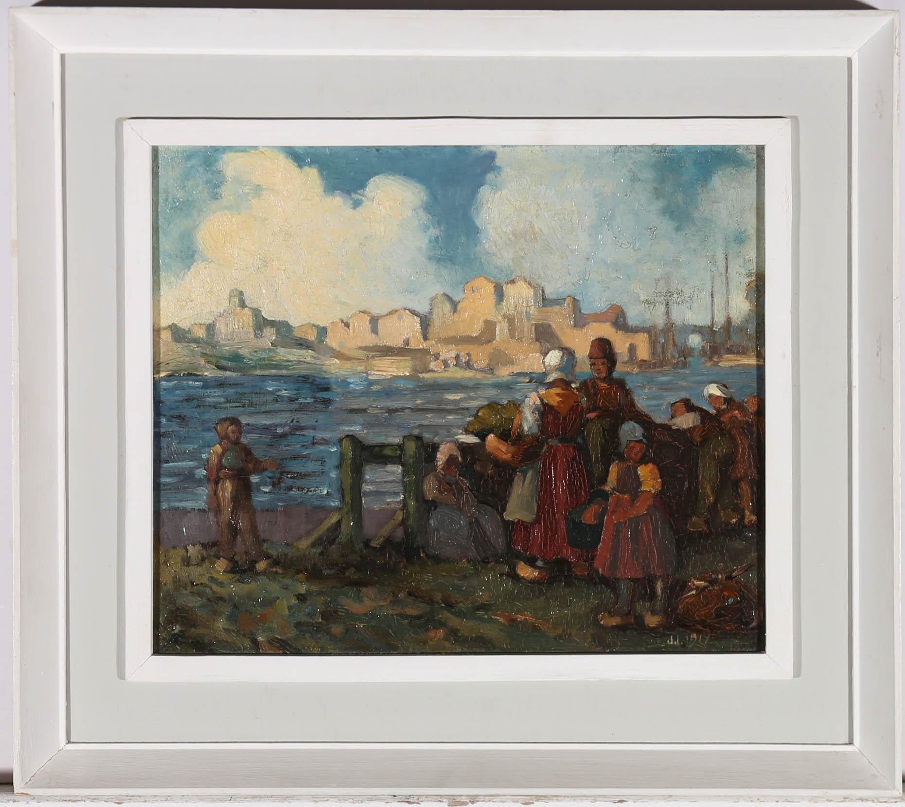 A charming Dutch harbour scene from the early 20th Century, showing a group of women and children, waiting at the edge of a sunlit harbour, for the fishing boats to return, with a distant town visible across the water. The artist has initialed
