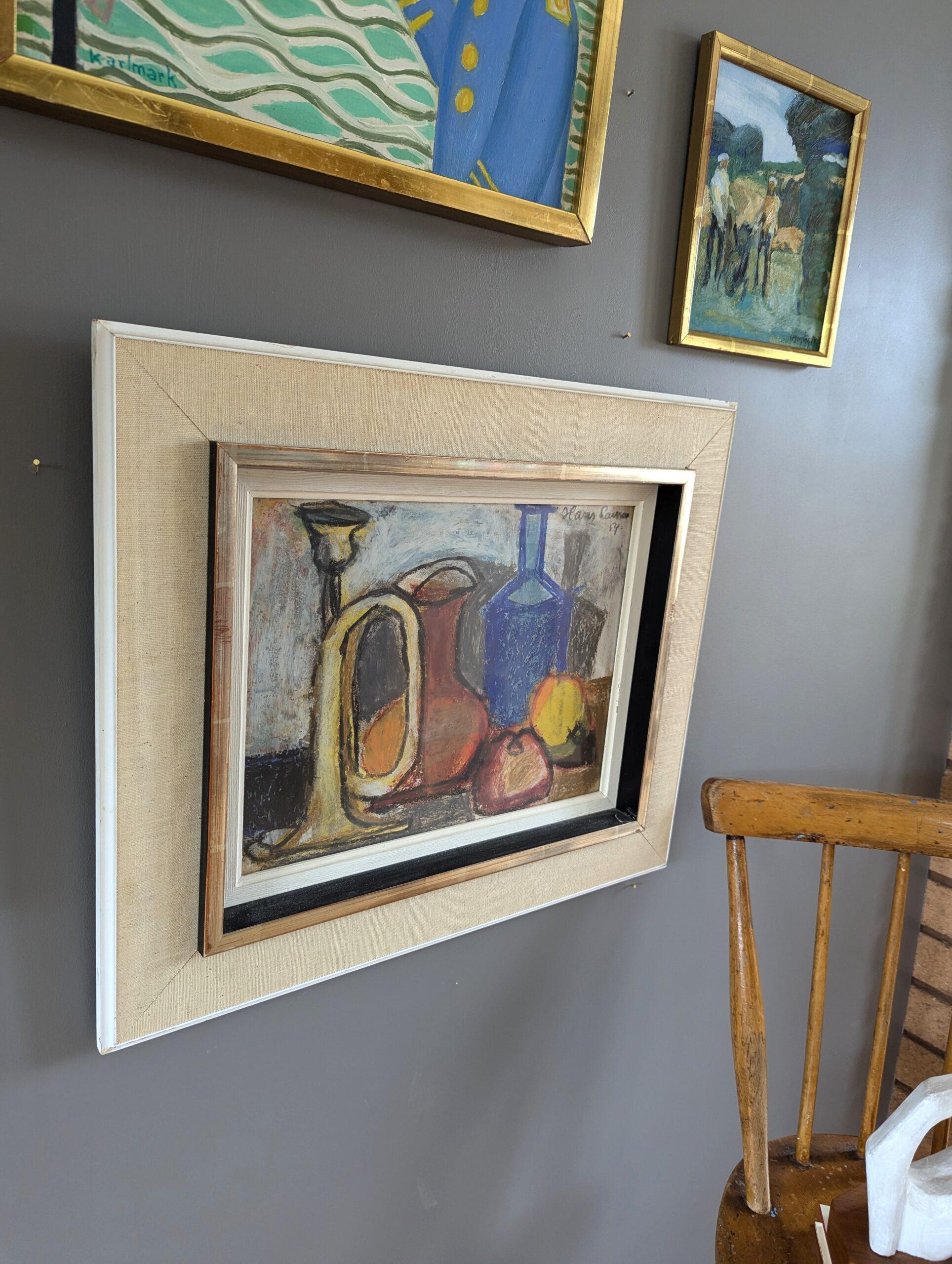 STILL LIFE IN PASTEL
Size: 42 x 49 cm (including frame)
Oil pastel on board

An expressive and lively mid-century still life composition with a rich palette of colours, rendered in pastel onto board and dated 1954.

An array of objects punctuates