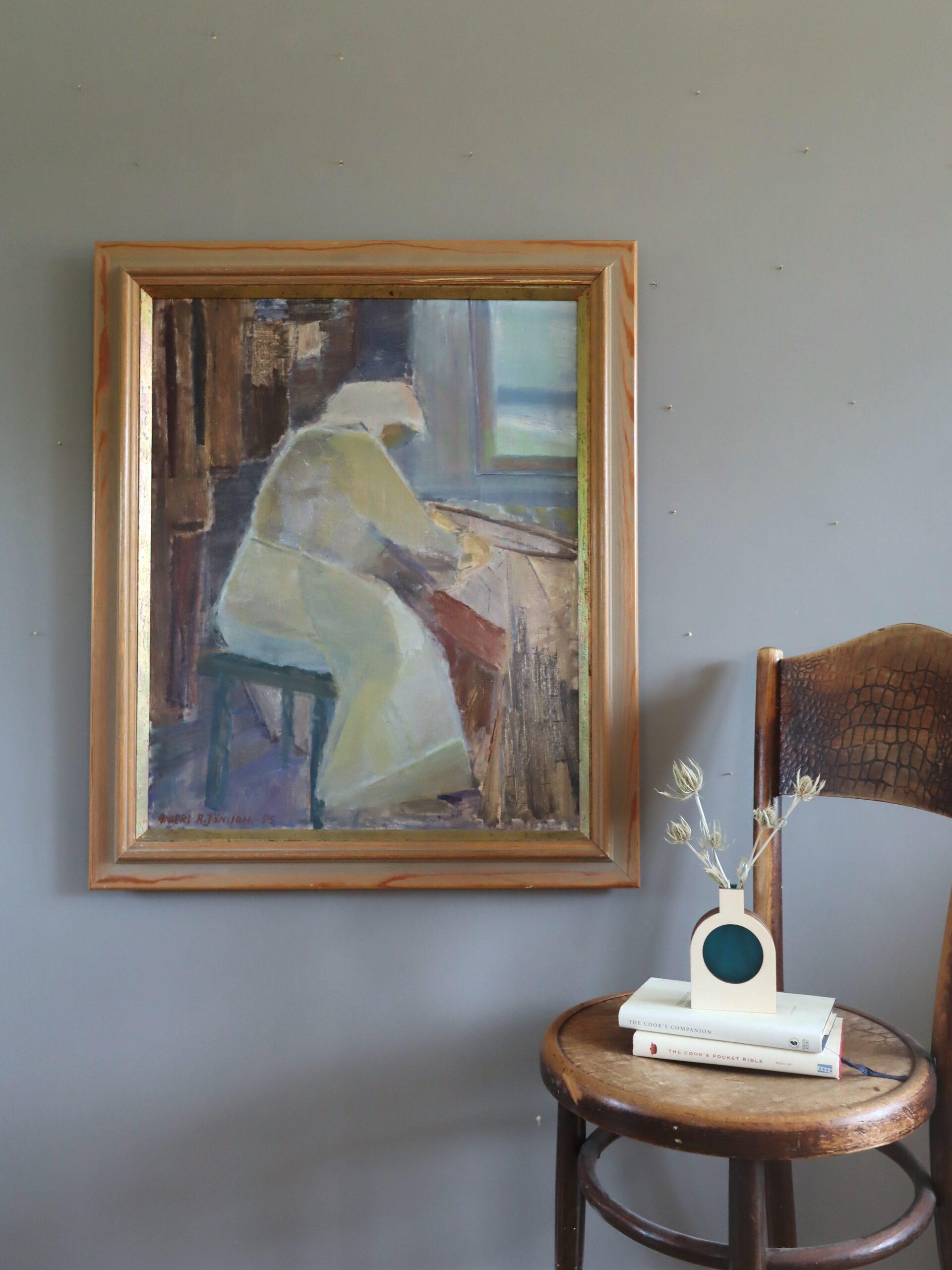 A MOMENT TO HERSELF
Size: 82 x 69.5 cm (including frame)
Oil on canvas

A mid-century figurative painting painted in 1955 that captures a contemplative figure absorbed in quiet work, seated near a sunlit window,  executed in oil onto canvas.

The