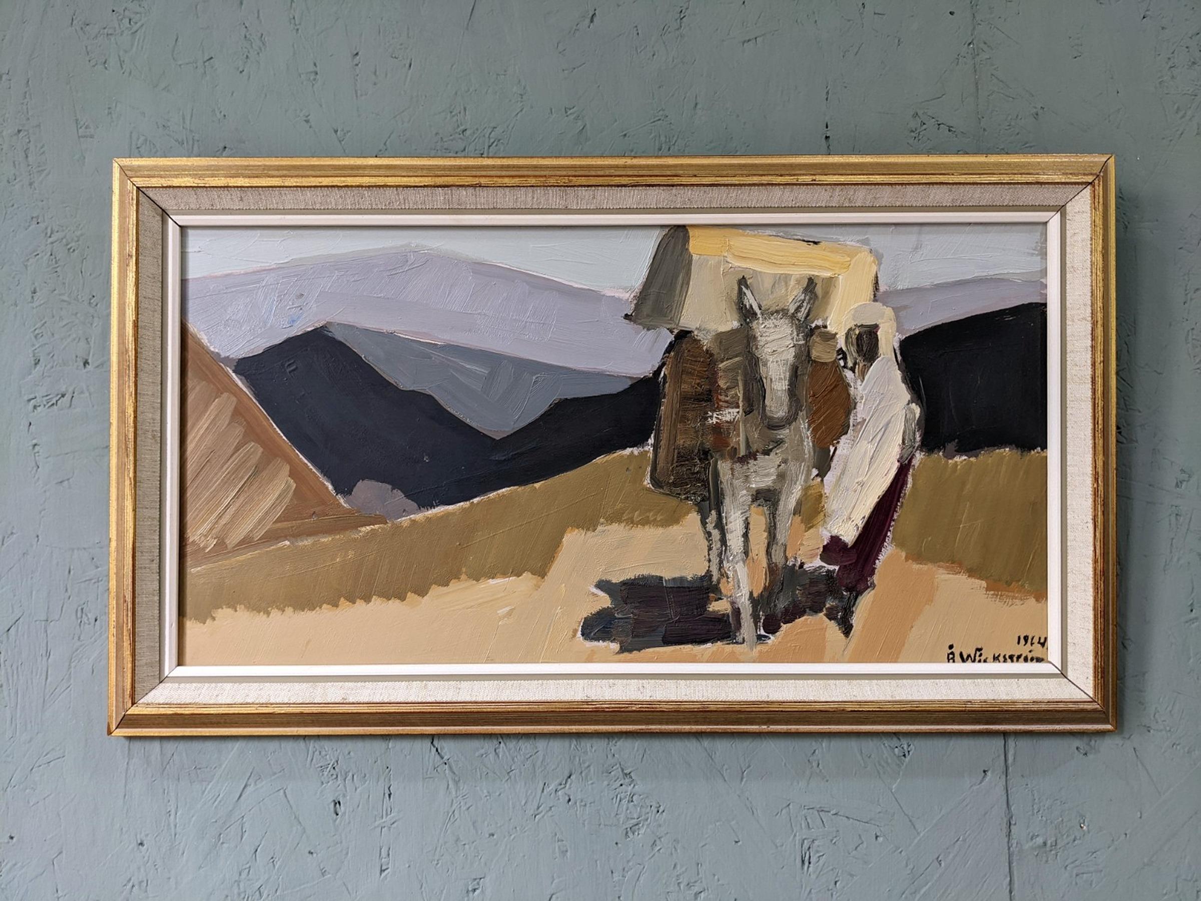 IN THE DESERT
Size: 30 x 52 cm (including frame)
Oil on Board

A very confidently executed modernist composition painted in oil onto board, and dated 1964.

This painting presents a figure and a donkey with a load on its back, crossing through a