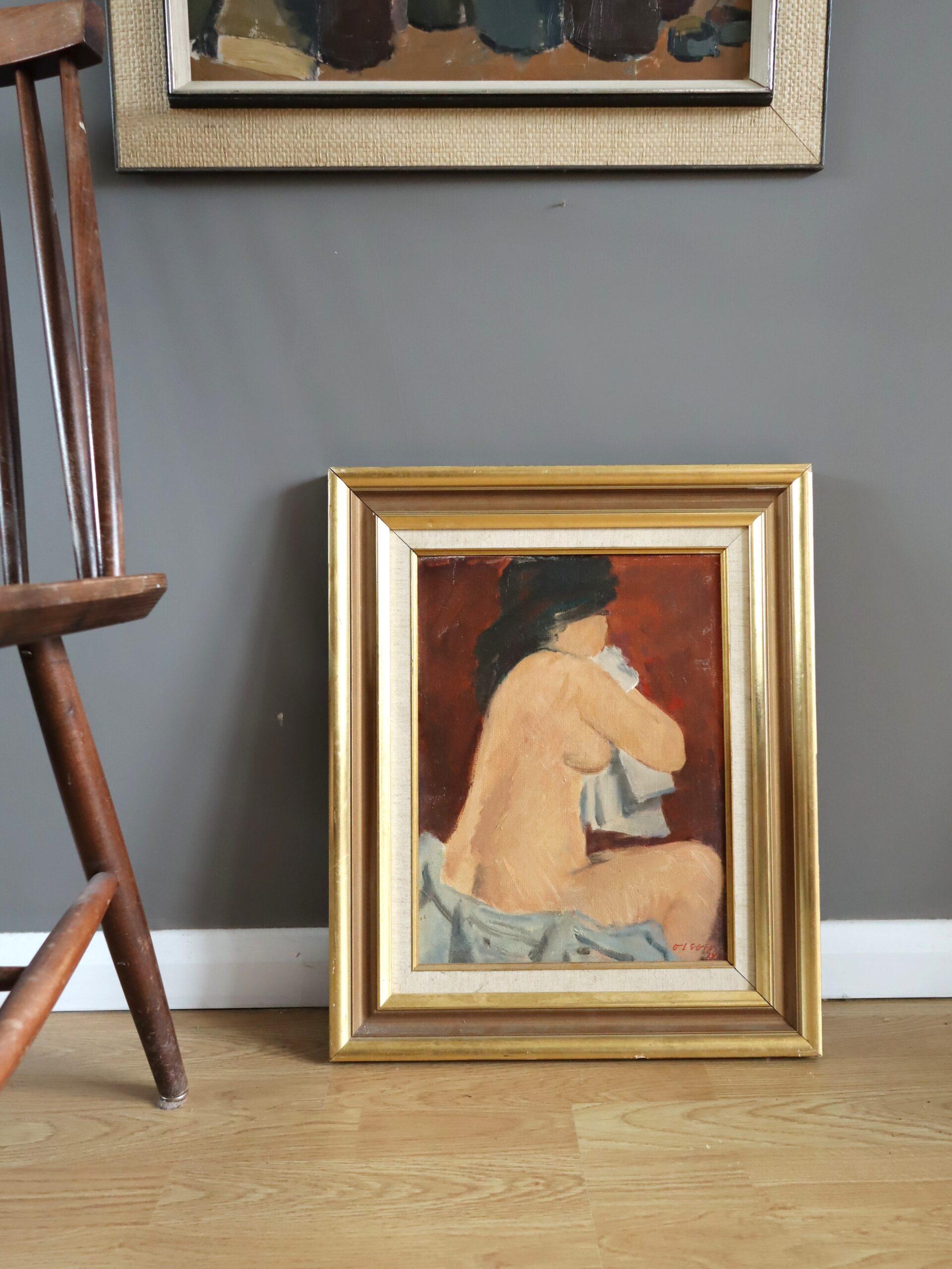 REPOSE BY RED
Size: 49 x 41 cm (including frame)
Oil on board

A brilliantly executed modernist nude study, painted in oil onto board and dated 1974.

This painting depicts a seated nude woman, turned away from the viewer, in a modest and