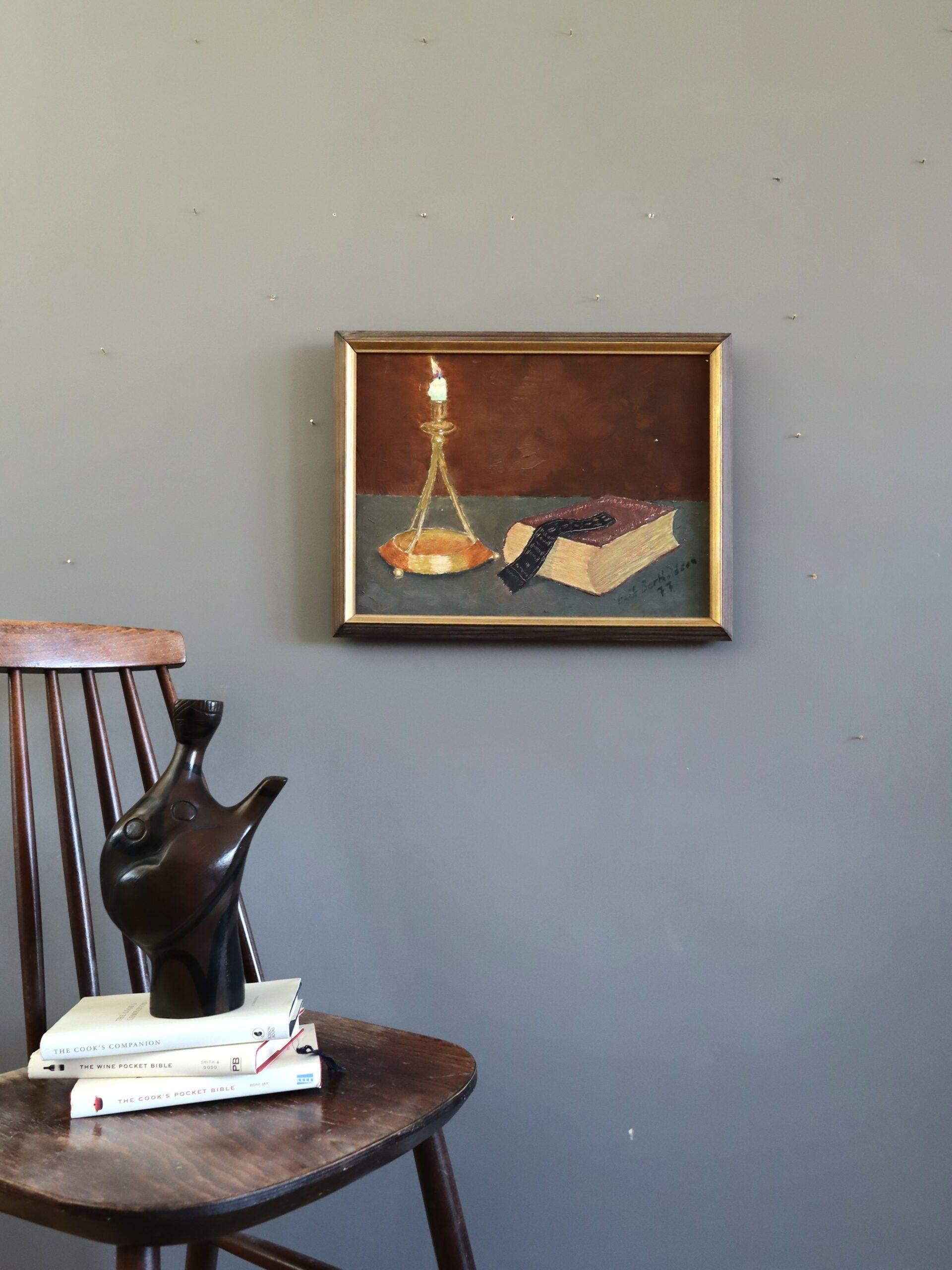 BY CANDLELIGHT
Size: 34.5 x 44.5 cm (including frame)
Oil on canvas

A poignant mid-century still life composition that evokes solitude and reflection, executed in oil onto canvas and dated 1977.

The painting presents a tall, elegant candlestick