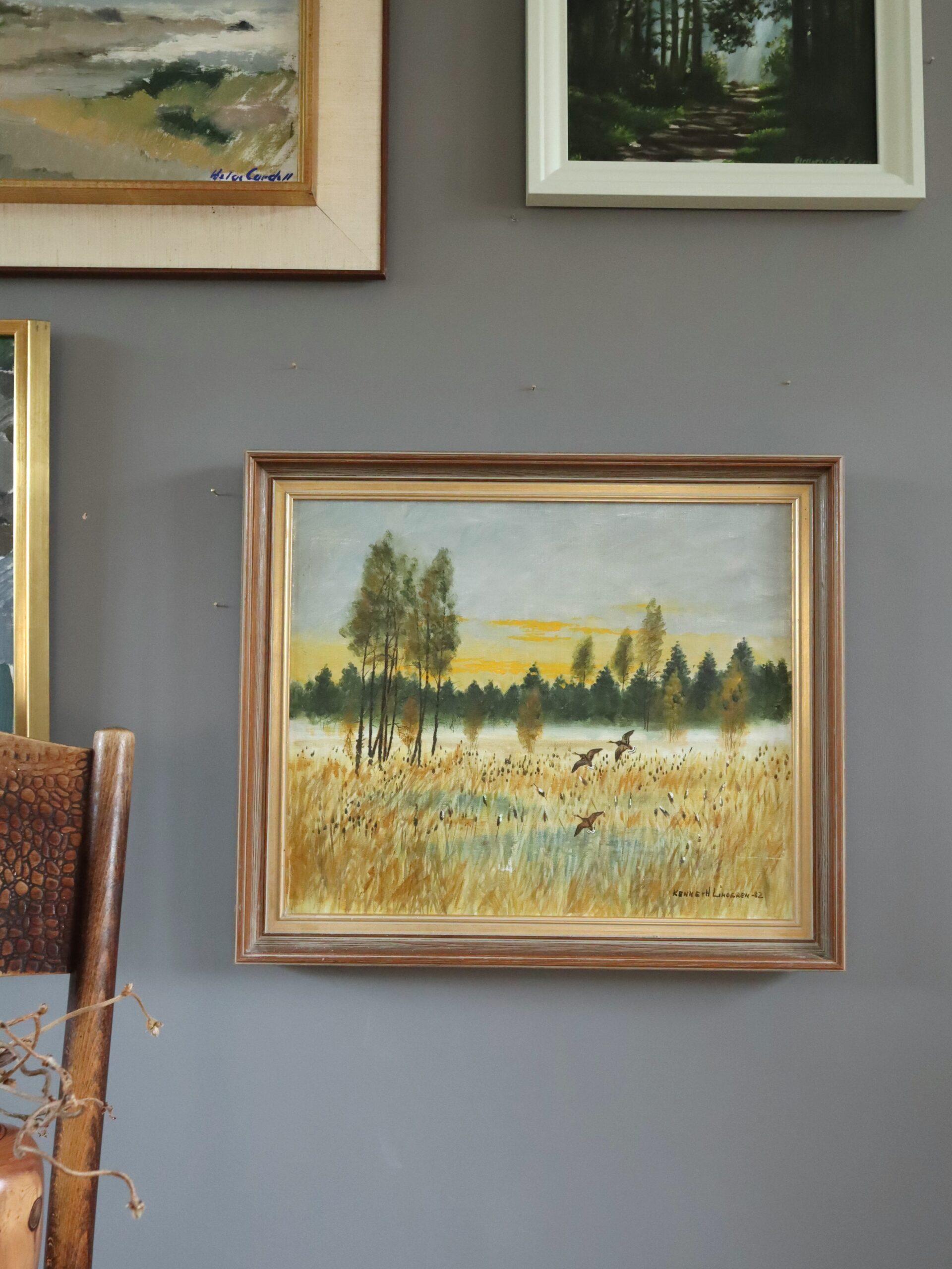 FLIGHT AT FIRST LIGHT
Size: 45.5 x 53.5 cm (including frame)
Oil on canvas

A serene and atmospheric landscape composition that captures the quiet majesty of a misty wetland at sunrise, executed in oil onto canvas and dated 1982.

The painting