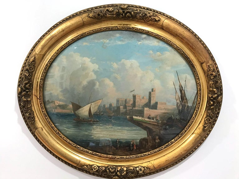 A pair of majestic 19th Century Oval paintings from the Continental School with beautiful details throughout. The sea scape scene is truly breathtaking depicting a castle with figures and ships on the water. The landscape scene is truly breathtaking