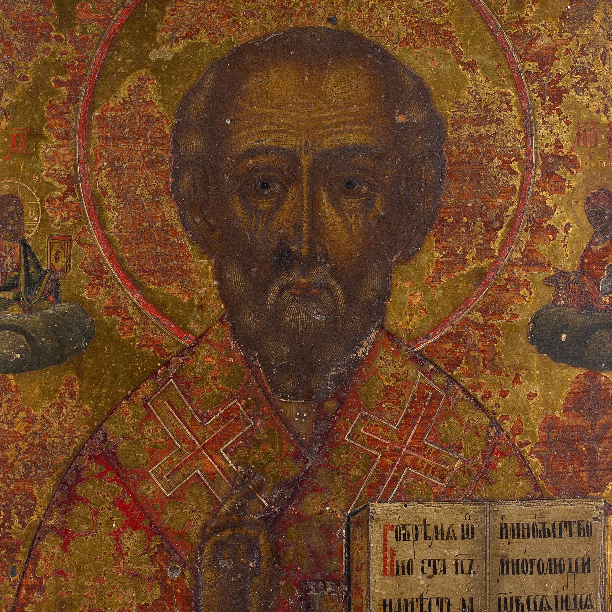 This late 19th-century Russian icon depicts Saint Nicholas of Myra, the wonderworker, flanked by images of Jesus Christ and Mary. He’s shown in half-length, dressed in vestments and holding the gospels in his left hand. 

Saint Nicholas was a