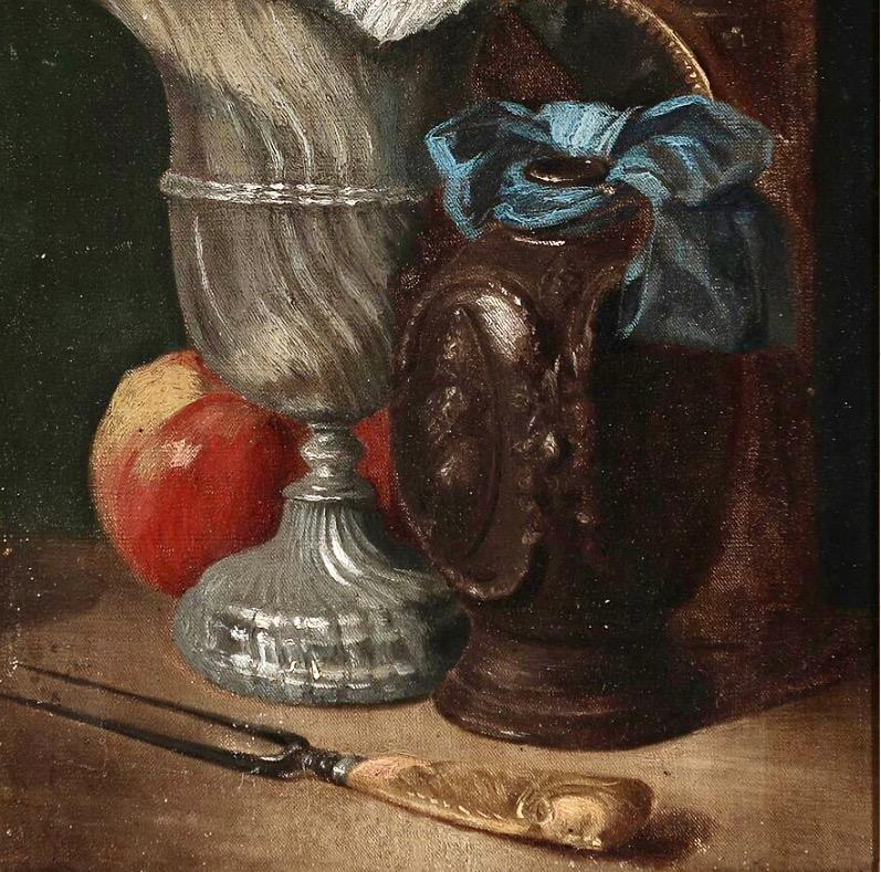 A charming 19th century still-life, oil on canvas depicting an 18th century wine ewer, lantern, stoneware tankard with a blue ribbon bow, fork with a sculptured ivory handle, and an apple on a table against a dark background. Not signed. The gilded
