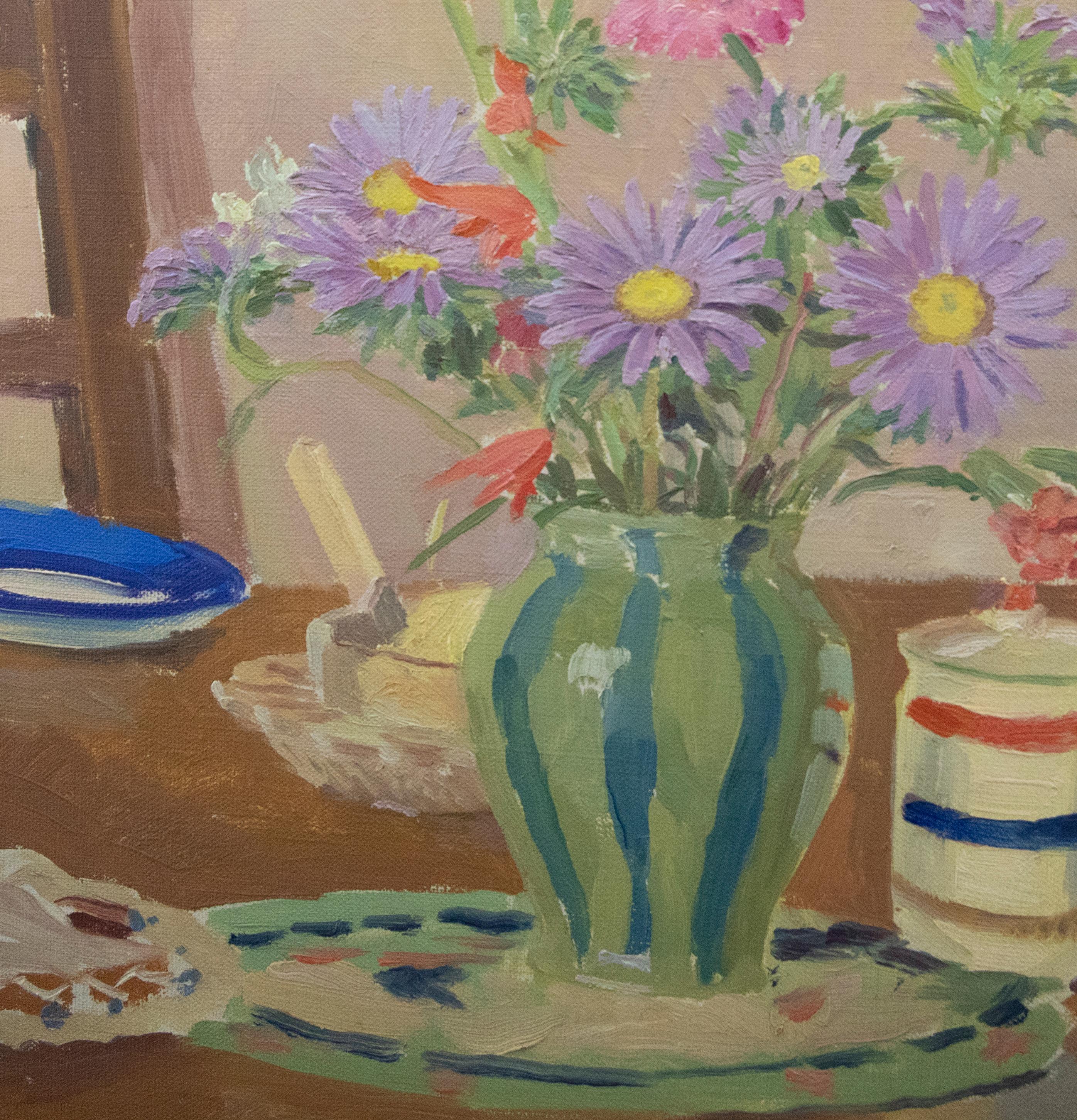 A delightful still life study depicting a striped glass holding asters in the center of a dining table. The artist uses a soft palette and fun patterns to capture this quaint but charismatic composition with a painterly finish. Unsigned. On canvas.