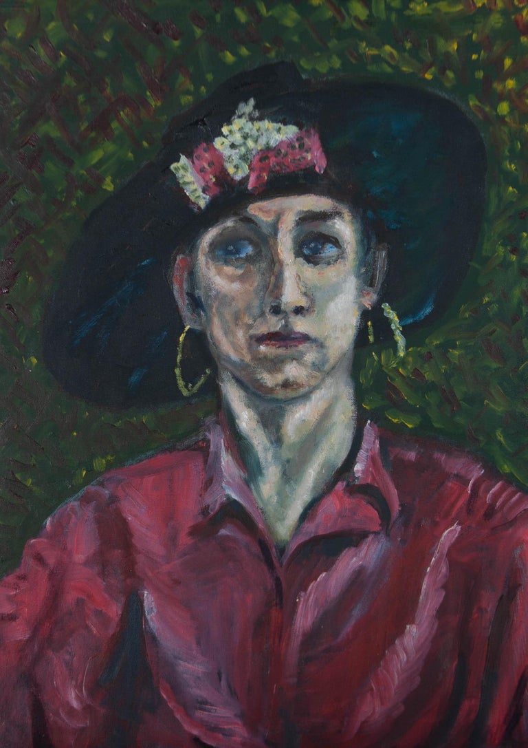 A striking portrait of a woman wearing a pink shirt, large hoop earrings, and a flamboyant hat. Presented in a dark-blue painted wooden frame. There is another painting to the reverse of the canvas of a seated male nude. Unsigned. On canvas on