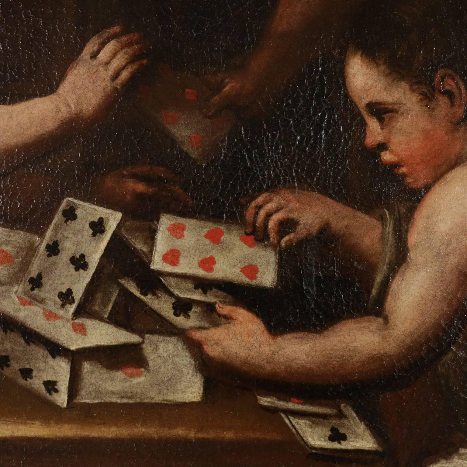Oil on canvas. The depicted scene is set in a closed environment with a wide window which provides a glimpse of landscape. Three cherubs are sitting on benches and they are playing with cards, trying to build a castle. The painting has been