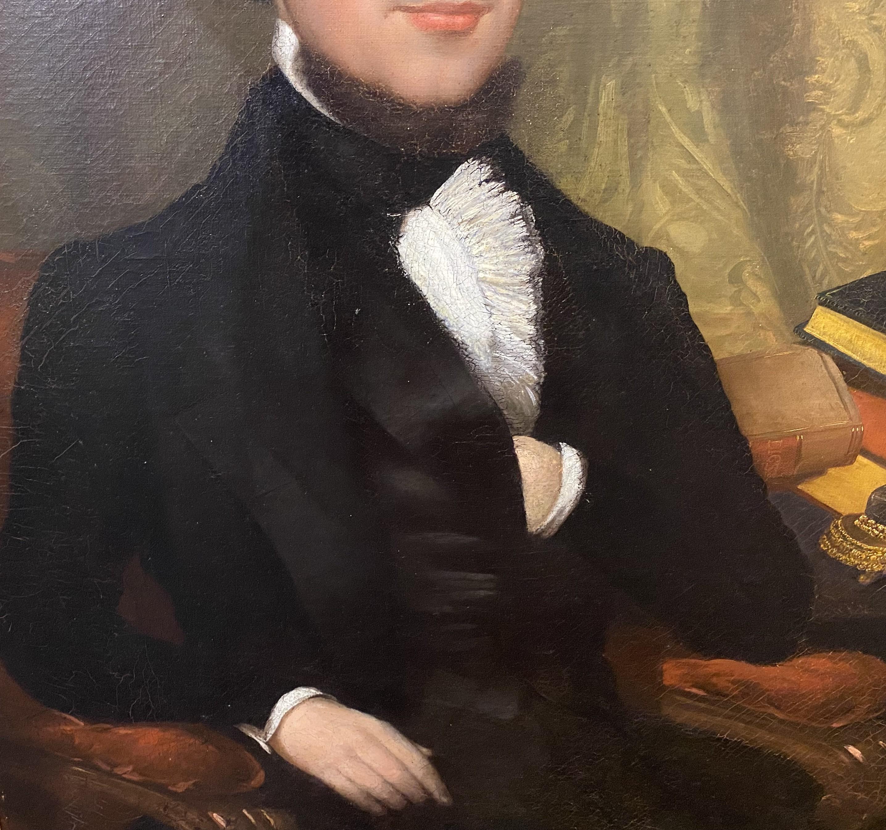 A fine American School oil portrait of an affluent gentleman or aristocrat in black with a ruffled shirt, seated at his desk with a nicely detailed gilt desk set with Cupid figure, inkwell, quill, and various books, with a bookcase and drapery