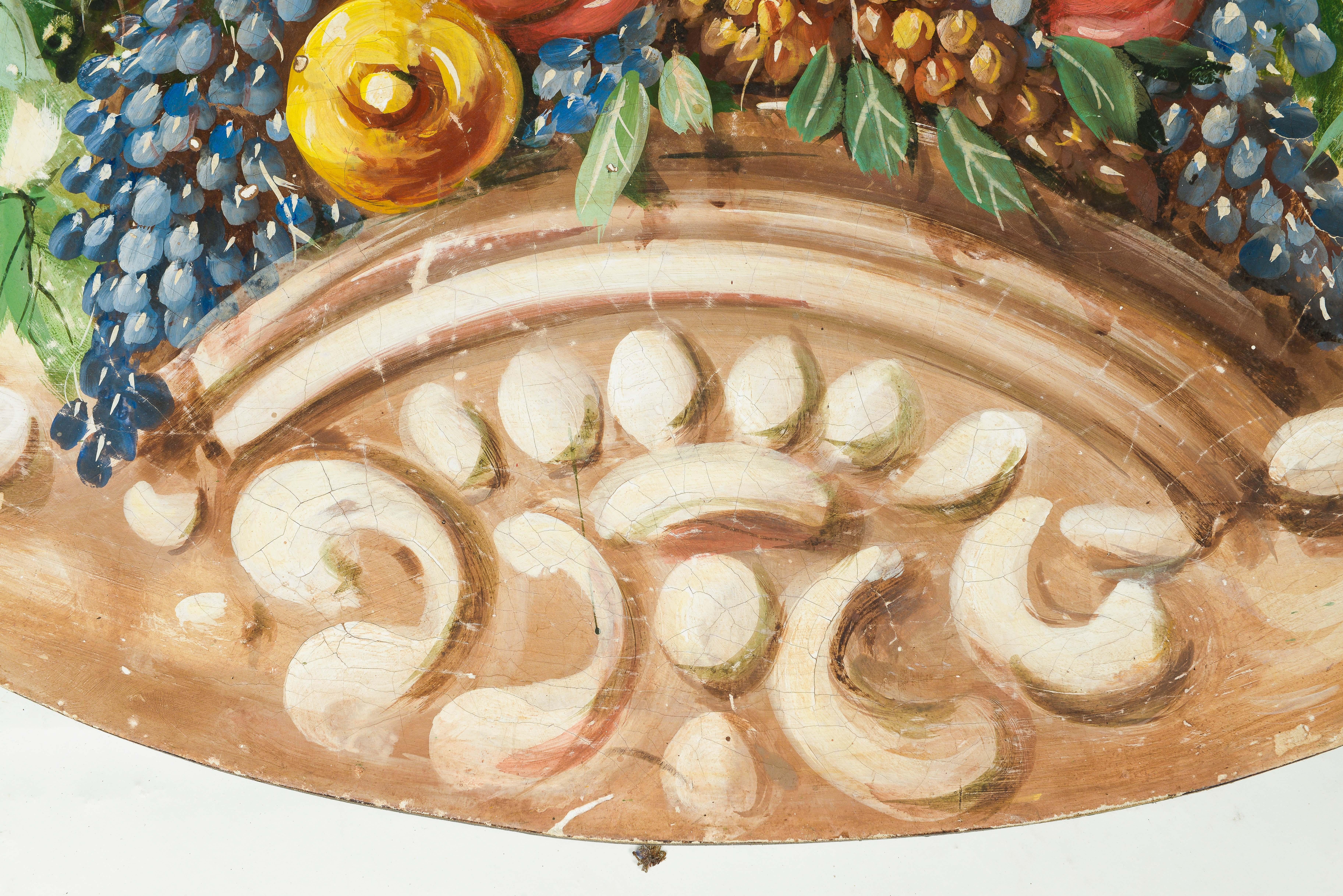 Depicting an abundant collection of grapes, apples, lemons and more set on a ledge within a rococo cartouche. Designed to be looked at from below.
