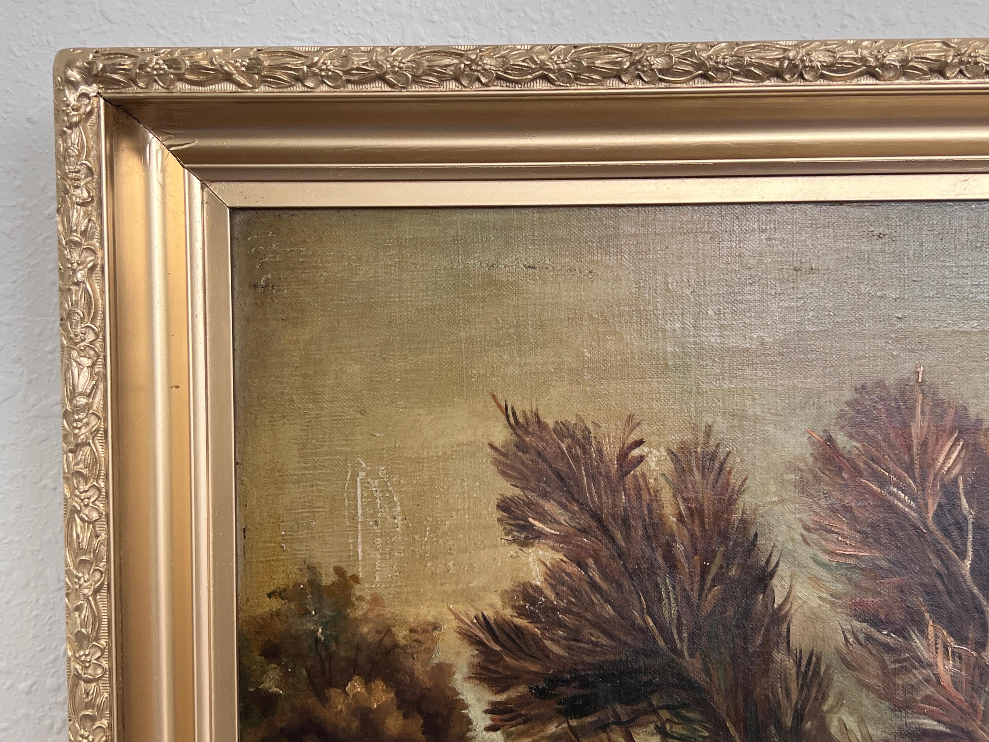 This evocative antique oil painting on canvas captures a tranquil rural scene bathed in the soft glow of a setting sun. A group of wind-swept trees stands along a peaceful pond, with delicate reflections mirrored in the still water. The warm, dusky