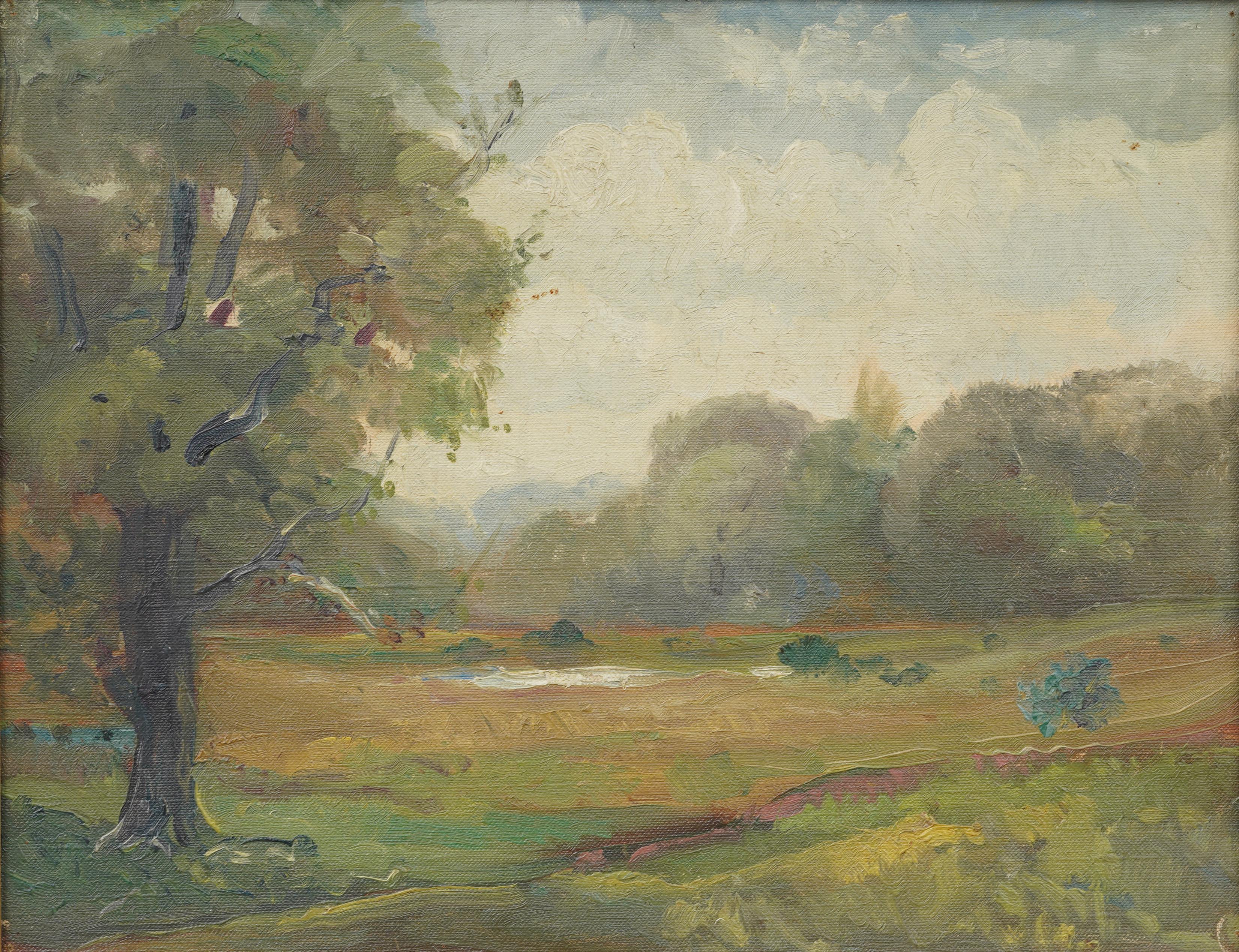 A peaceful early 20th-century landscape by J.M. Livens, signed and dated 1924 on the reverse. The painting depicts a wide meadow under soft afternoon light, bordered by trees and punctuated by a large foreground oak rendered with expressive
