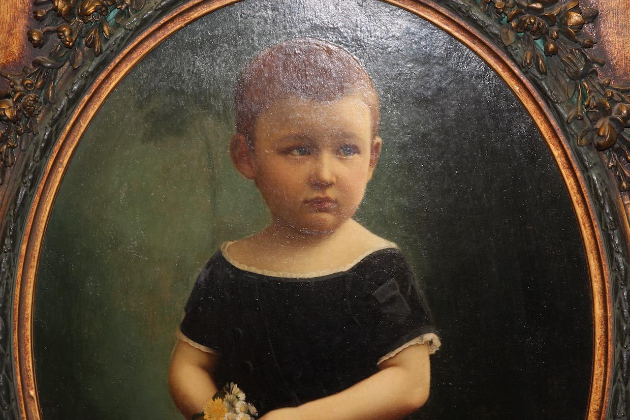 Décoration, peinture à l'huile ancienne. Portrait d'enfant avec cadre orné.