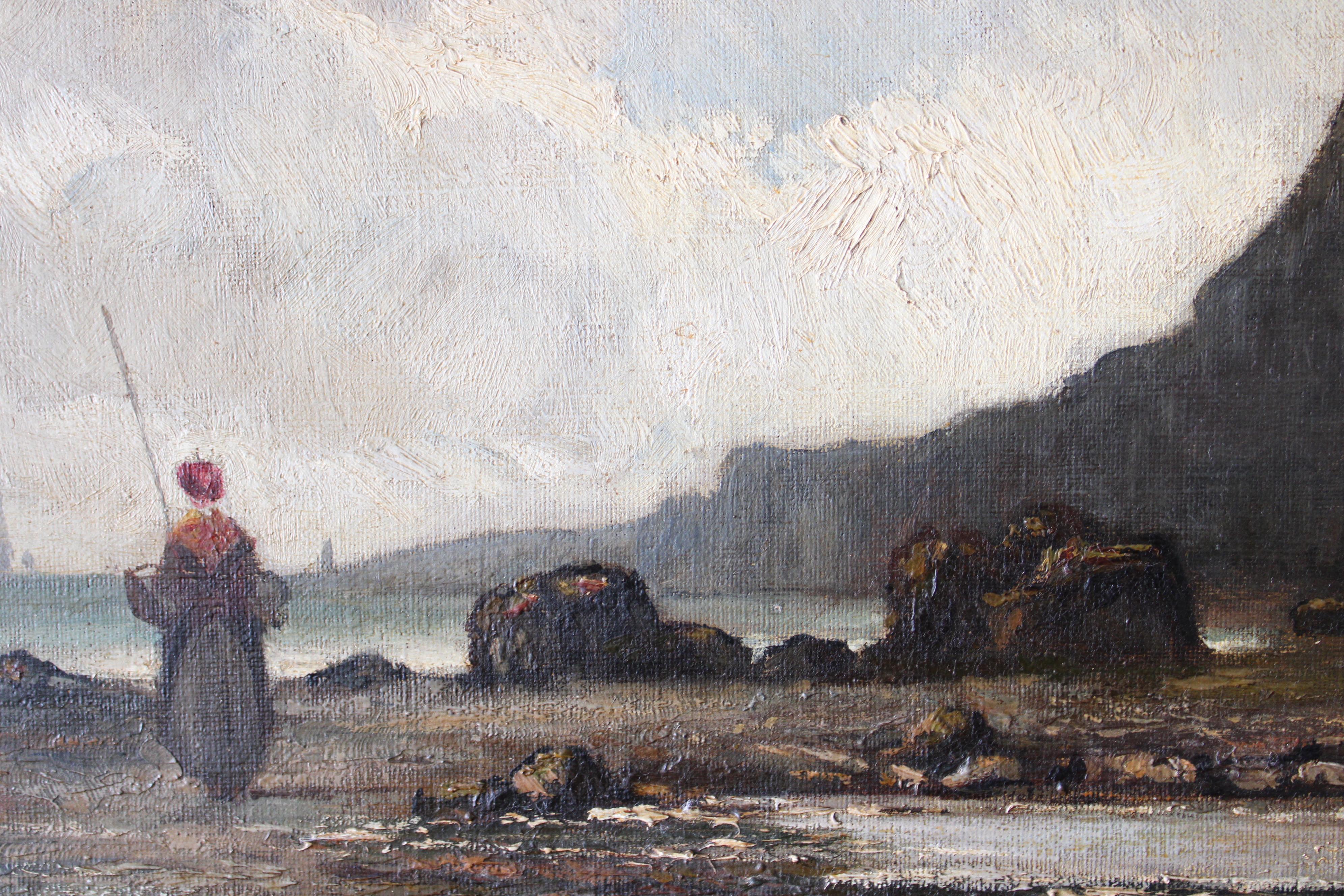 Antique French seascape coastal oil painting from the  early 1900's signed and dated in the bottom right.  A beach scene with a woman fishing.  A rocky beach in the fore with sailing ships on the horizon. It's well painted and very atmospheric with