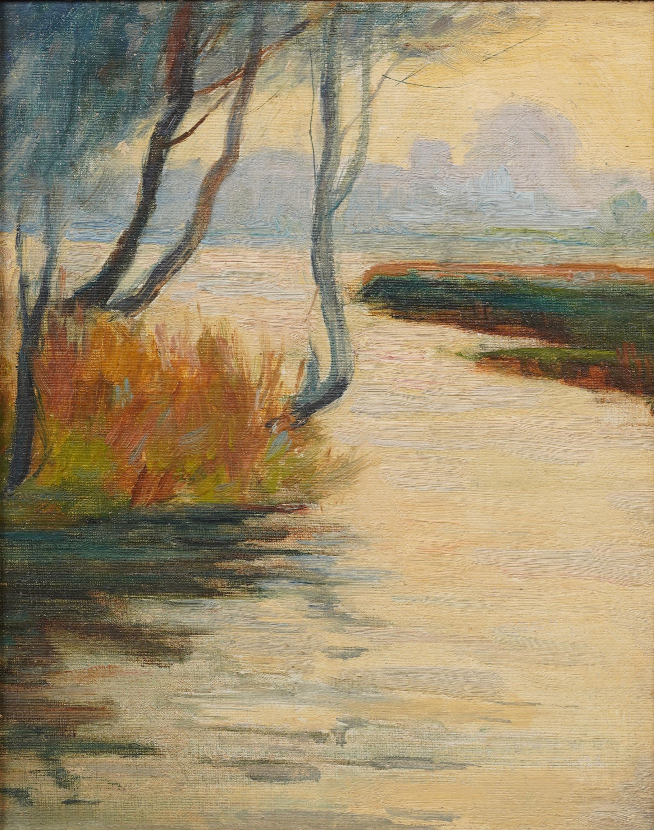 Charming early 20th-century oil landscape depicting a quiet riverside scene with trees, reeds, and soft reflections in the water. Painted in a gentle impressionist style with atmospheric tones of green, ochre, and sky blue. Presented in an ornate