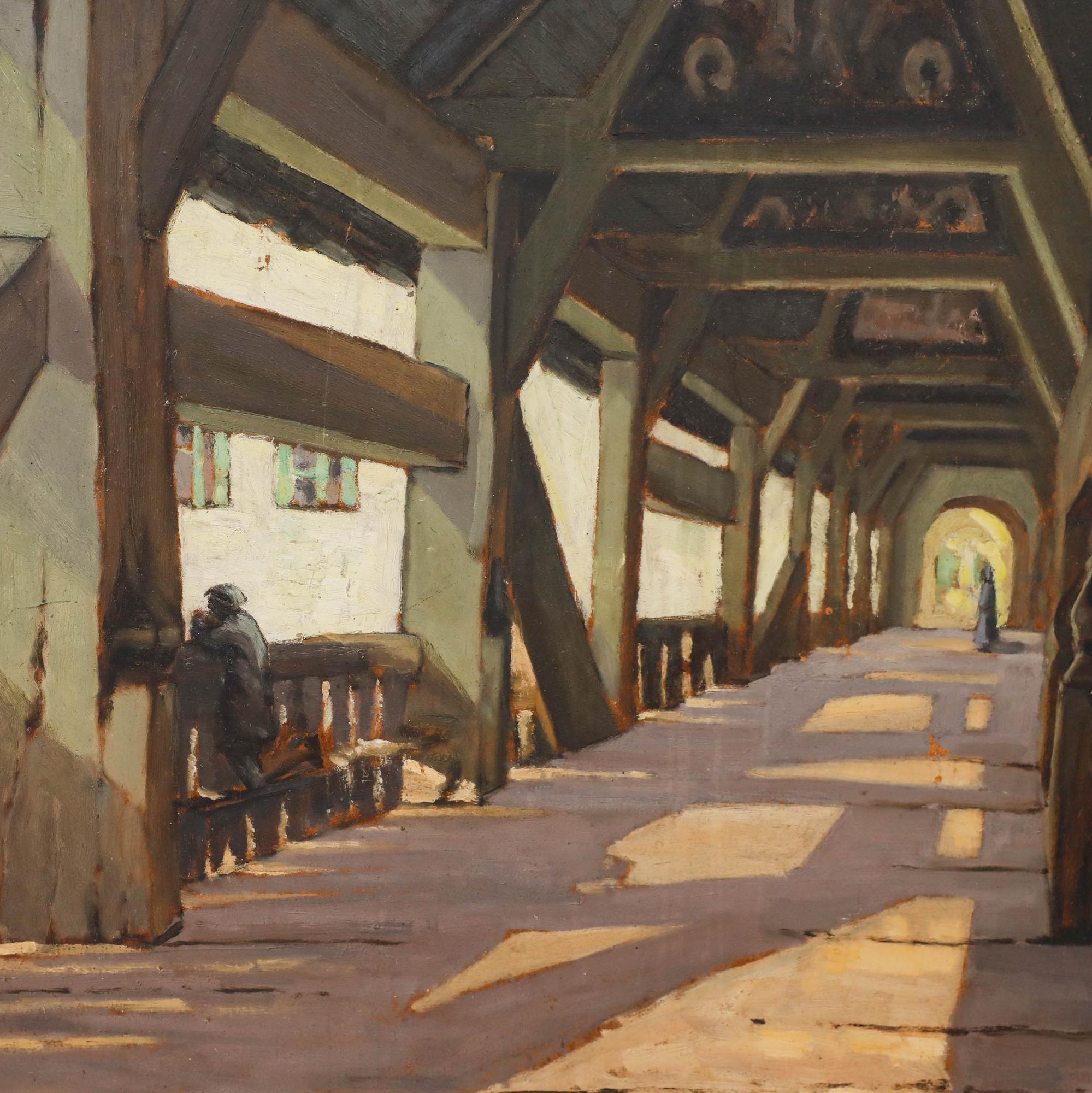 The sturdy beams of an old wooden bridge cast shadows across the floor, while a figure leans on the balustrade to admire the view. A label to the reverse identifies this as a bridge over the Guadalquivir river in Spain. Unsigned. On board.