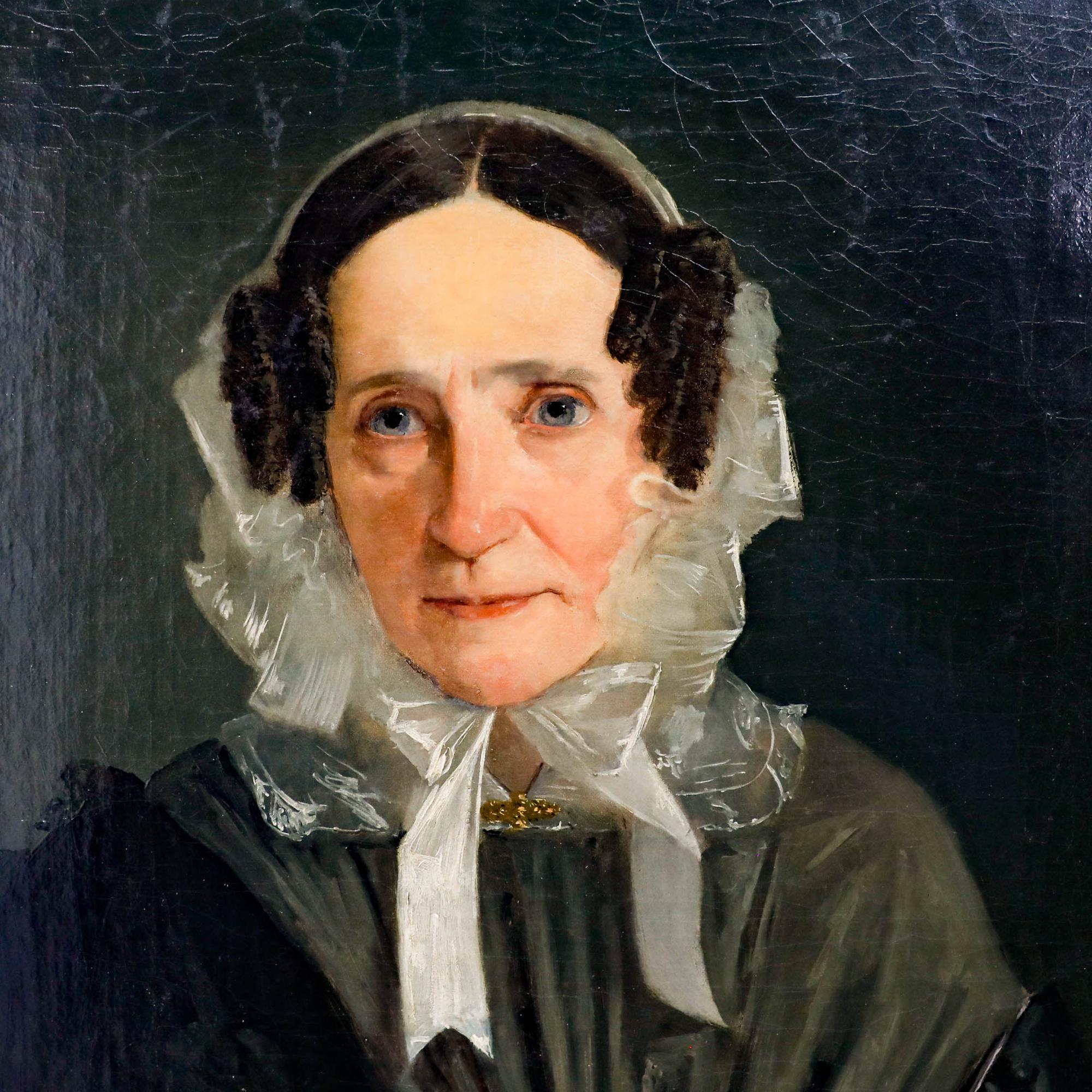 A fine oil portrait depicting a middle-aged woman sporting a grey silk dress and lace bonnet. Acquired as a pair together with a portrait of her husband by the same hand. 

Unsigned. Presented in a swept gilt frame with ornate foliate and hatched