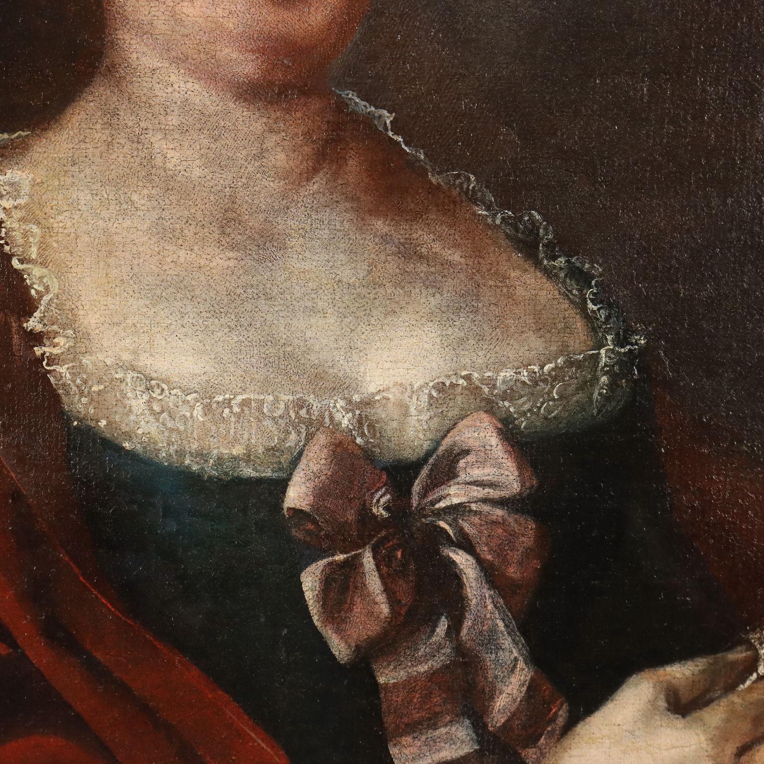 Olio su tela.
La nobildonna è riccamente abbigliata, con un'elegante cappa rossa poggiata sulle spalle, che lascia scoperto l'abito orlato di pizzi; l'acconciatura è impreziosita di perle.
In alto a destra sulla tela,  compare anche lo stemma del