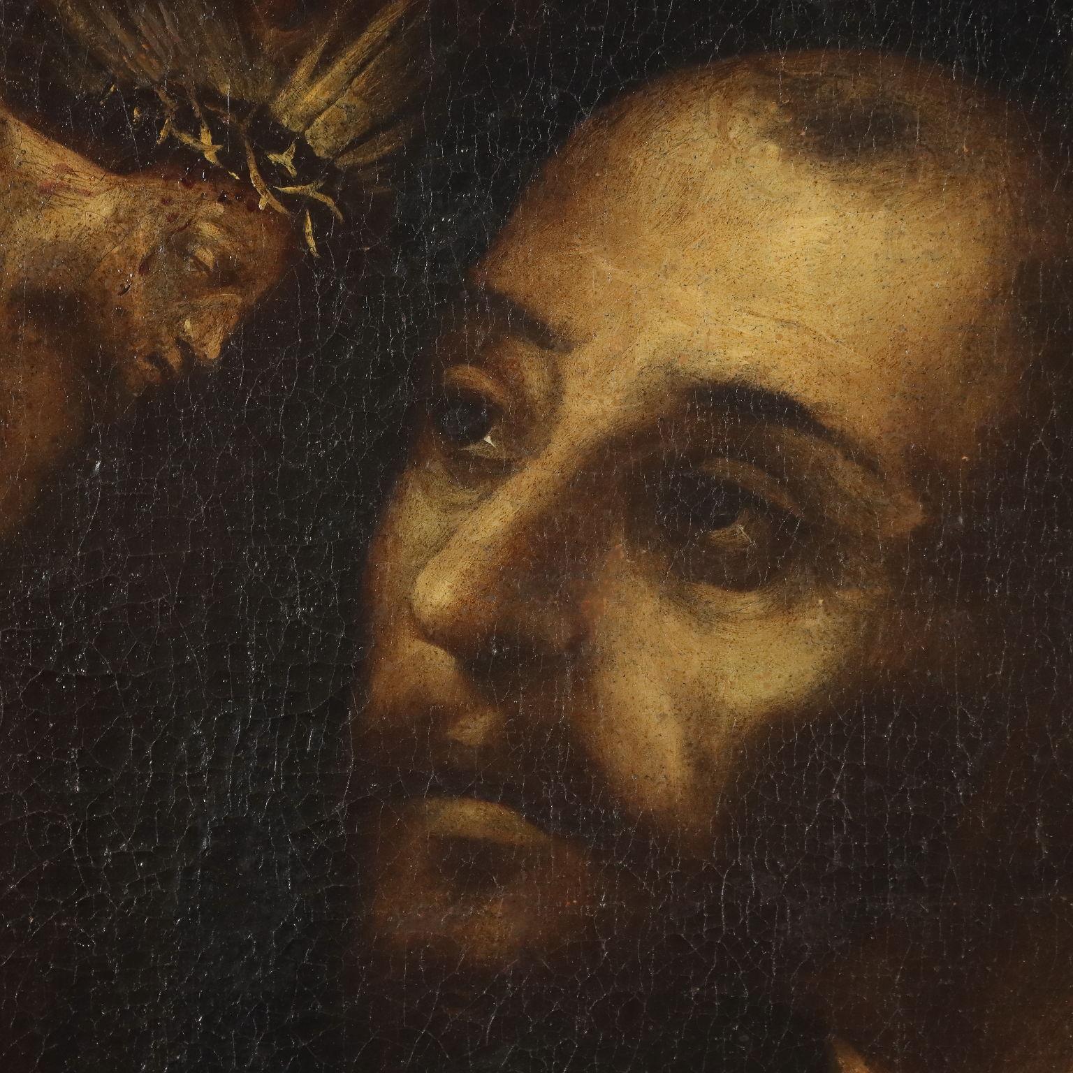 Olio su tela.
Il Santo, in primo piano, è raffigurato in ginocchio, adorante il Crocifisso che regge con una mano, mentre l' altra indica in basso il teschio, il tradizionale 