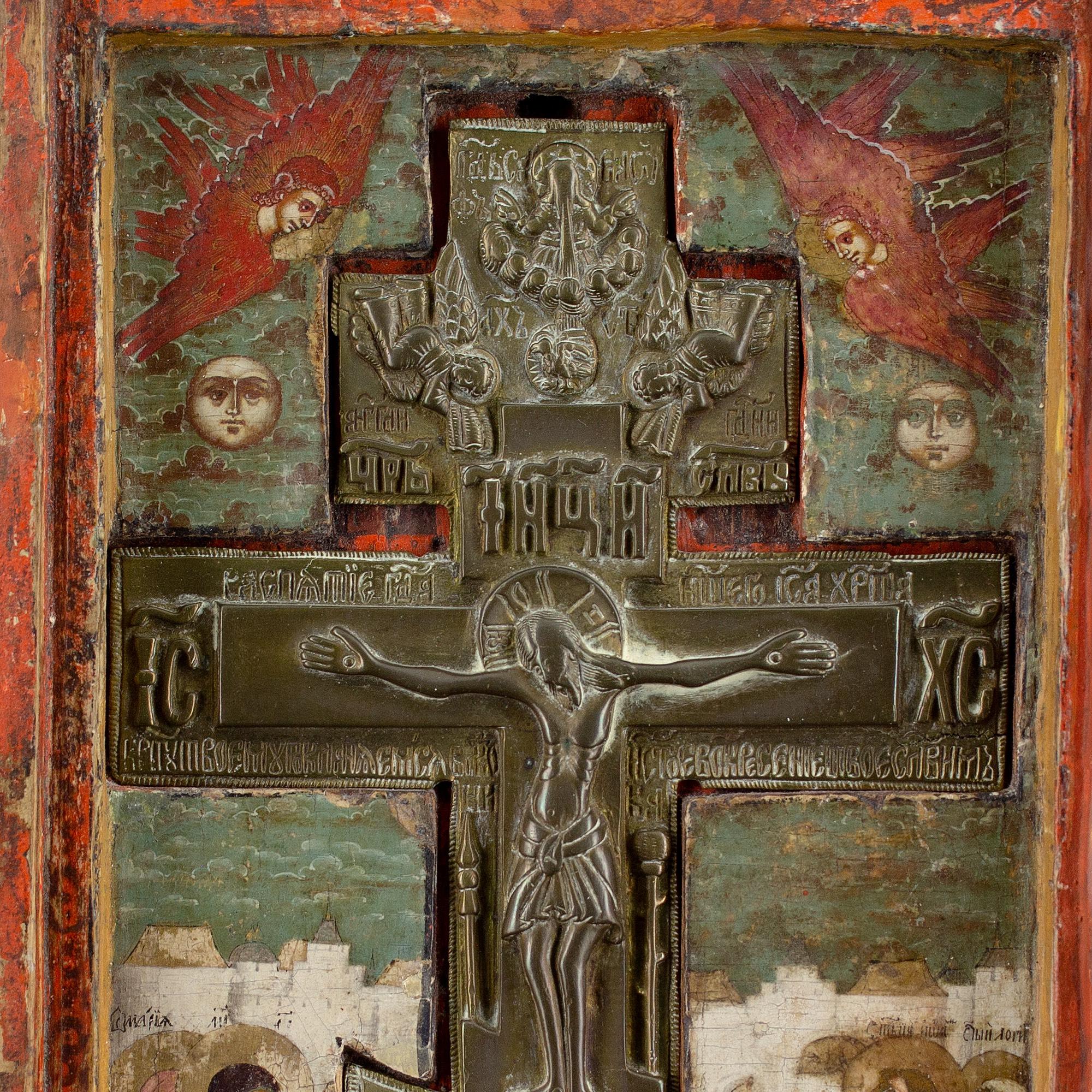 This exquisite and exceedingly rare early 18th-century Russian Staurotek icon depicts The Crucifixion of Christ with an assemblage of saints, together with a 19th-century copper-cast eight-pointed cross, inserted in the central recess.

Due to the