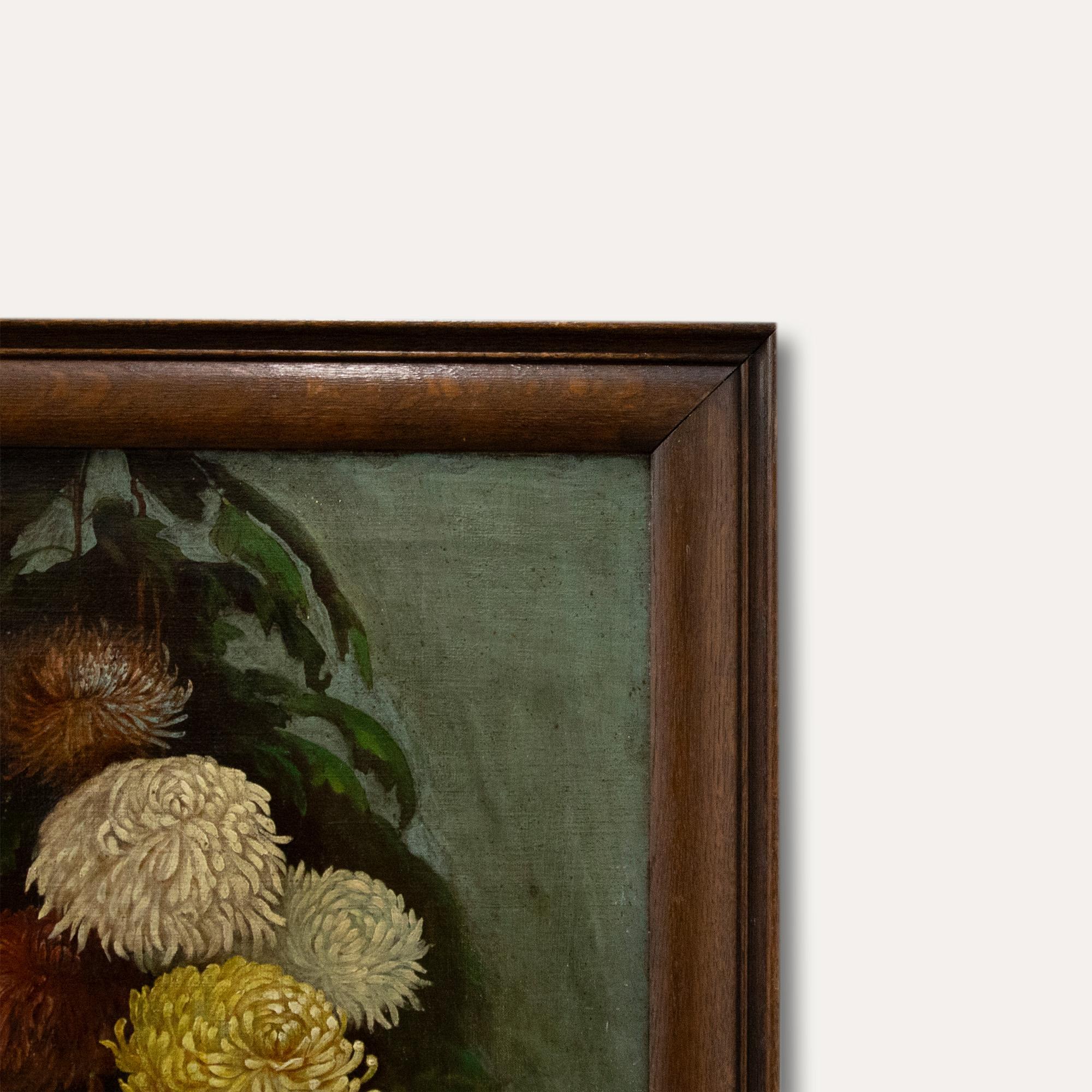 A delightful study of Chrysanthemums in yellow, red and orange growing in a garden. The bright blooms have a striking appearance against the darkened leaves and evening sky. Unsigned. Presented in an oak frame, On canvas.