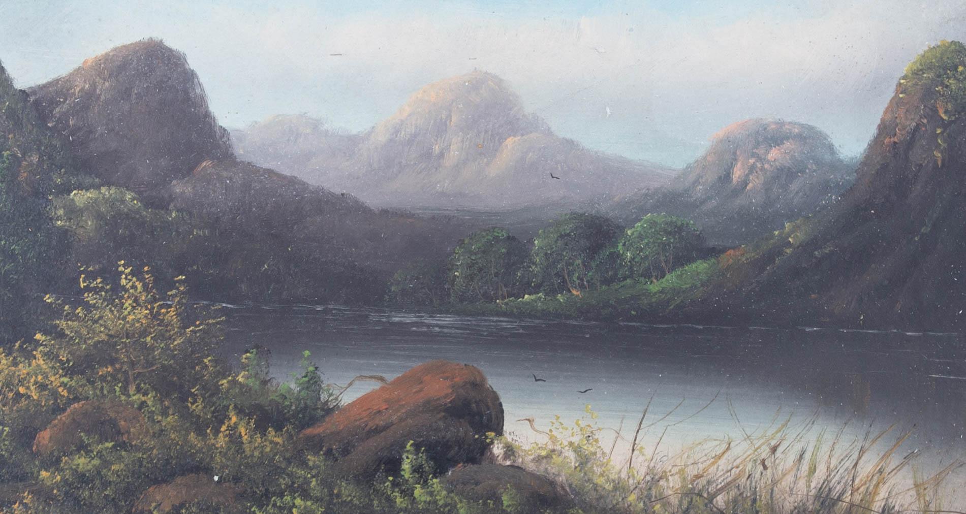 A charming oil on board of a lake set beneath the rocky mountains in the distance. The work has been well presented in a gilt mount and detailed gilt frame. Unsigned. On board.
