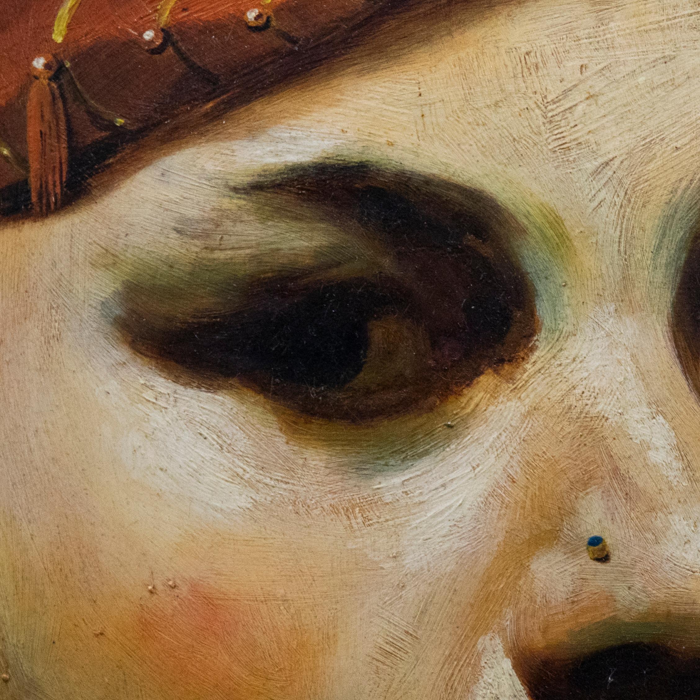 Une étude de portrait saisissante représentant un gros plan du visage d'un jeune homme. Le portrait porte un anneau dans le nez et un chapeau à glands, et il regarde du coin de l'œil. Signé et titré au verso. Présenté dans un cadre doré. A bord.