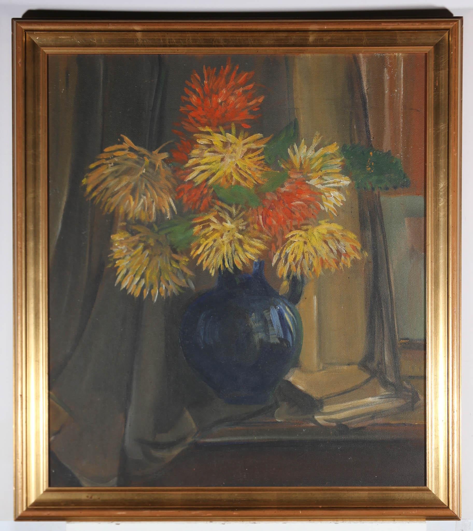Luminous Dahlias sing brightly from a blue lustre vase, in this confident example of a floral still life. The artist has signed and titled the work to the reverse (illegibly), and the painting has been beautifully presented in a substantial