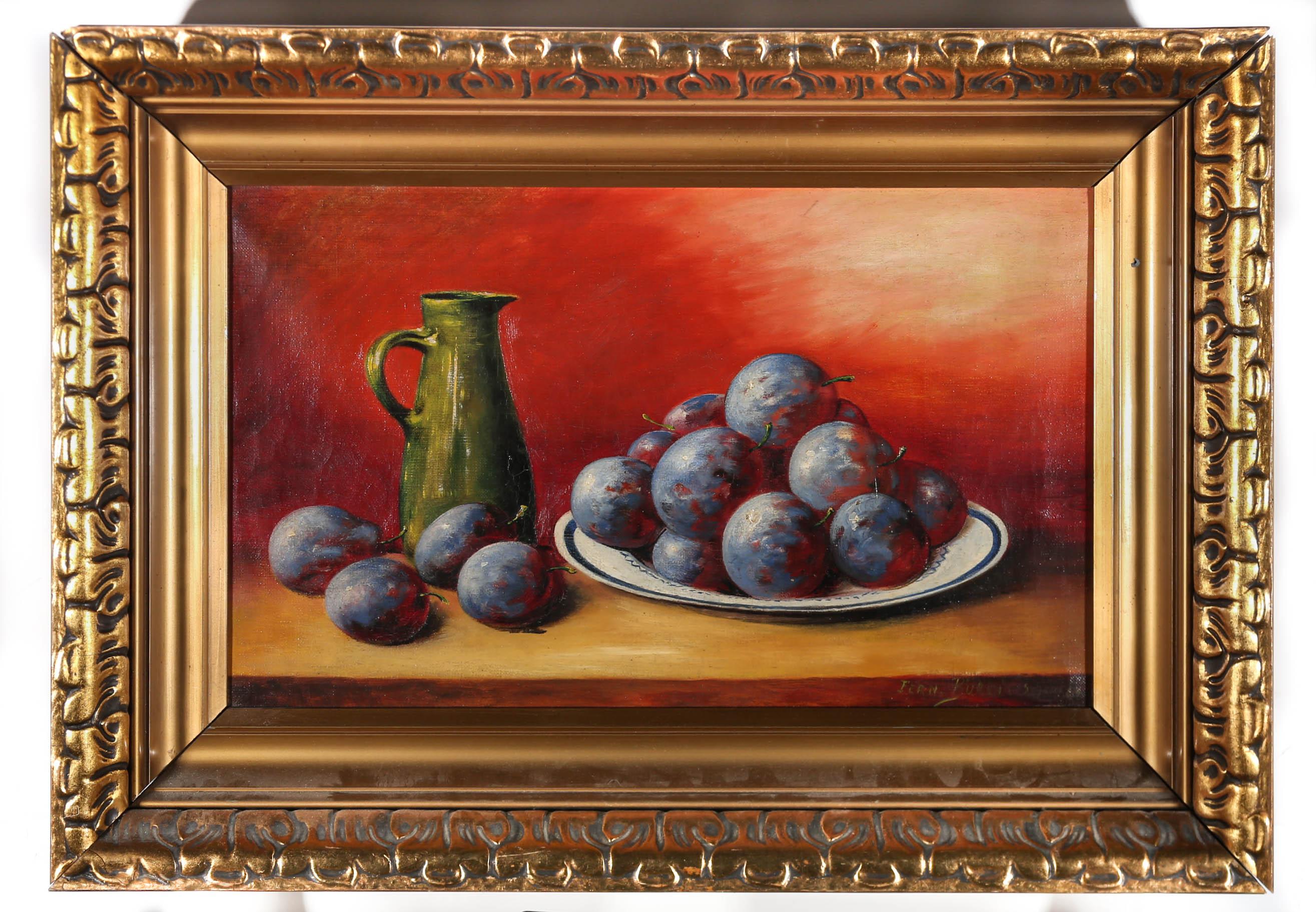 A vibrant sunset backdrop sets the tone for this quirky still life of sumptuous plums, mounded beside a gleaming green water jug. Indistinctly signed to the lower right. The oil comes presented in an extravagant deep sided frame with oversized