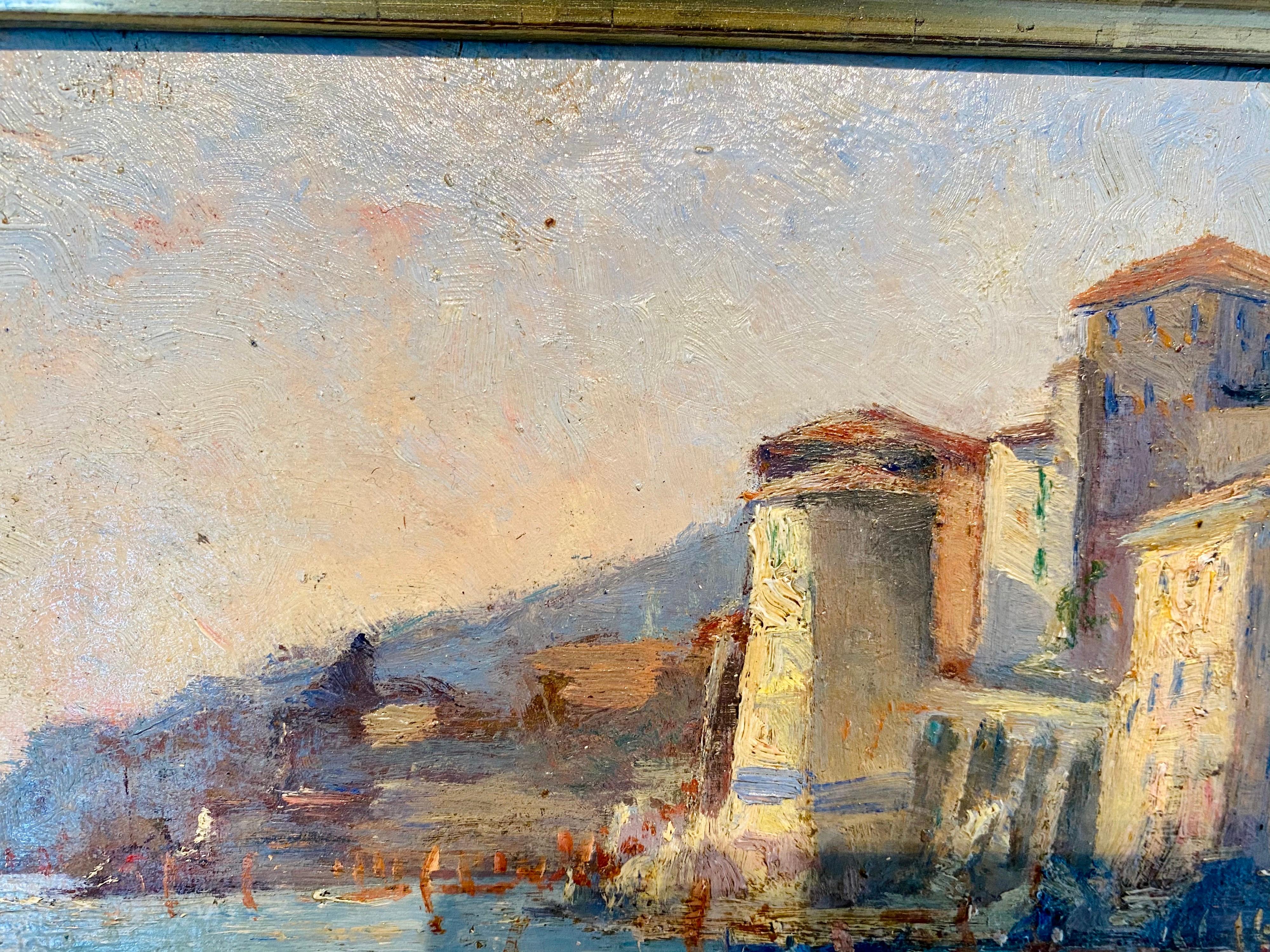 Beautifully vibrant French impressionist painting depicting a seaside village and harbour along the Mediterranean at dusk. Housed in a wonderfully matching frame. One can delightfully notice the warm light of the setting sun reflecting on the