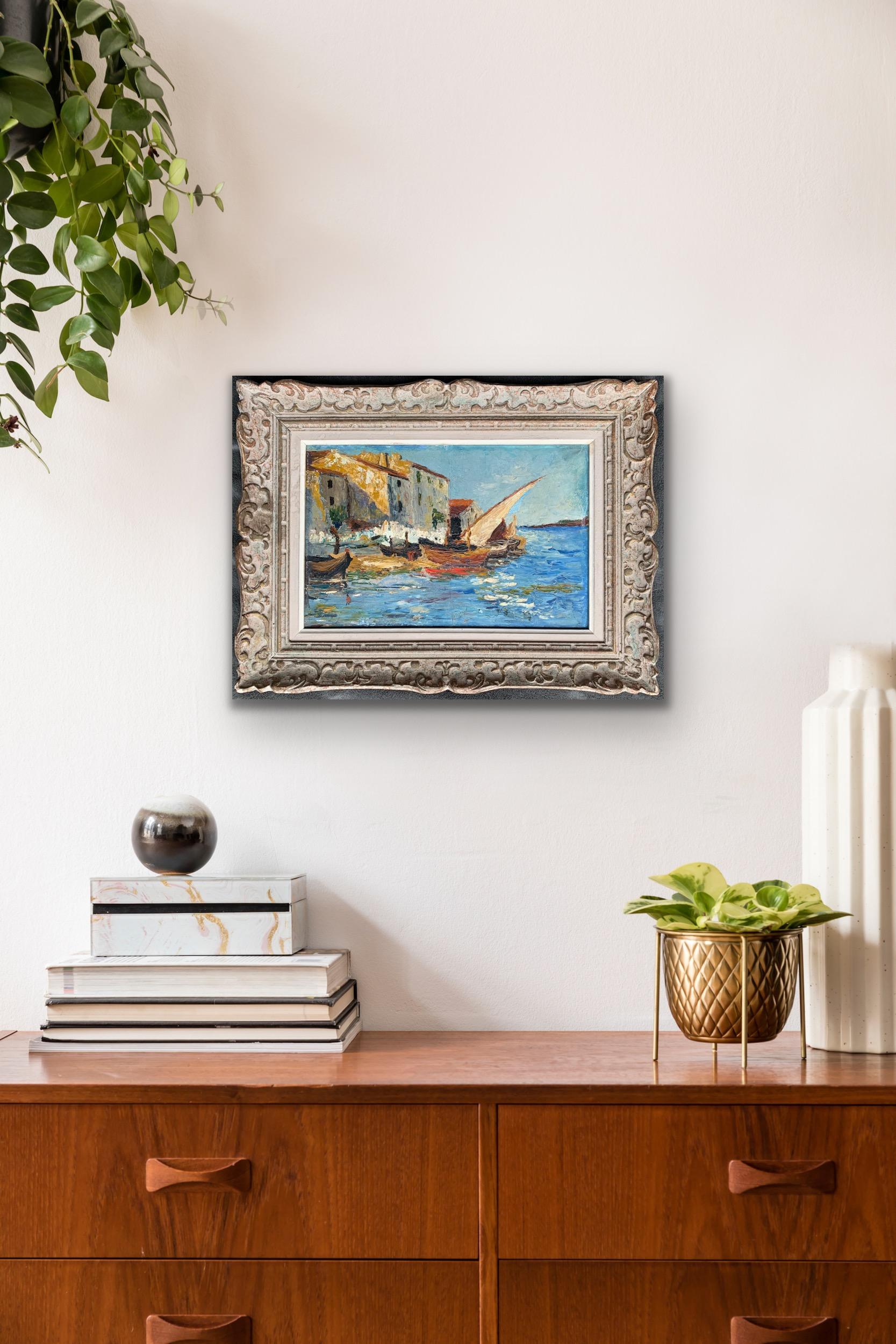 Beautifully vibrant French impressionist painting depicting a small harbour along the Mediterranean. Housed in a wonderfully matching frame. One can delightfully notice the sunshine reflecting on the buildings and small waves of the azure blue