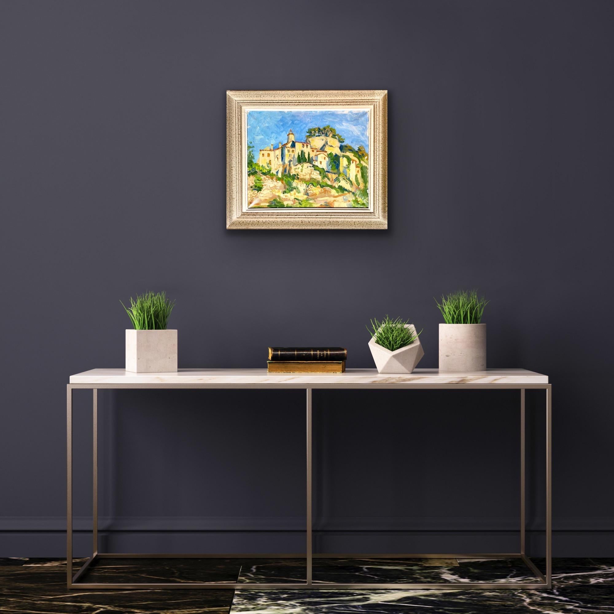 Wonderful and vibrant French painting depicting a hilly countryside landscape (likely in Provence) with a tiny and picturesque village which is nestled on top of a rocky hill between pine trees. The sky is delightfully blue, showing us that this