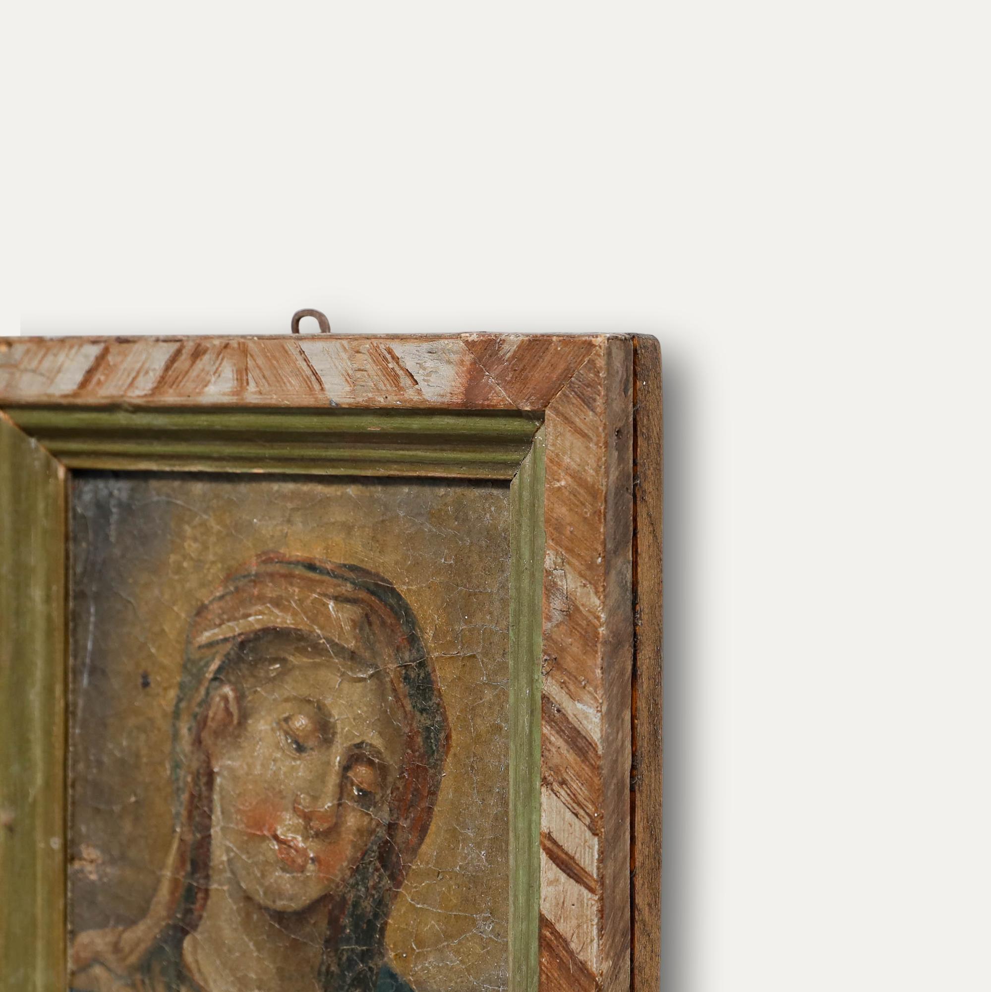 This early devotional painting depicts a serene female figure, possibly the Virgin Mary, with eyes closed and head gently inclined. The composition is rendered in soft, muted tones and delicate highlights. The piece is presented in a painted wood