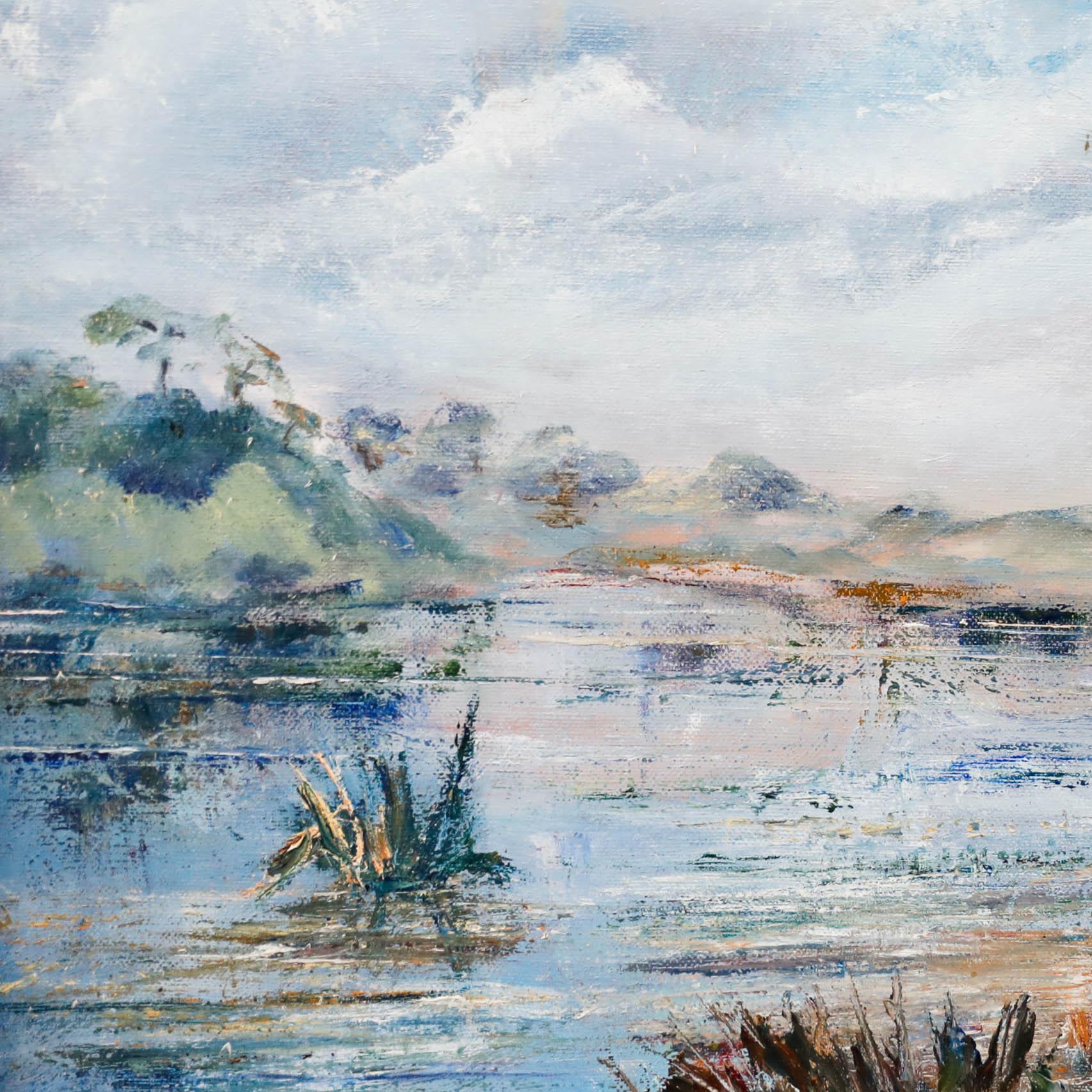 A charming landscape scene looking out over a peaceful lake to distant hills. Part of a pair of paintings by the artist titled 'Back of the Quail Garden'. Signed to the lower right. Presented in a wooden frame. On canvas.