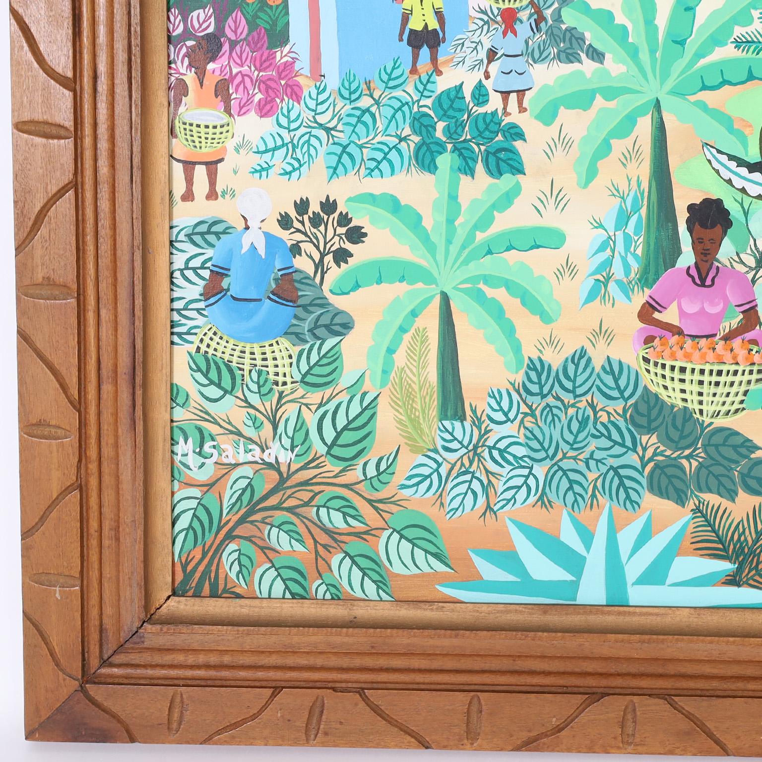 Pintura acrílica haitiana sobre lienzo de vivos colores que representa el quehacer cotidiano de una aldea tropical ejecutada con una característica técnica naif, firmada por M. Saladin y presentada en el marco original de madera tallada.
