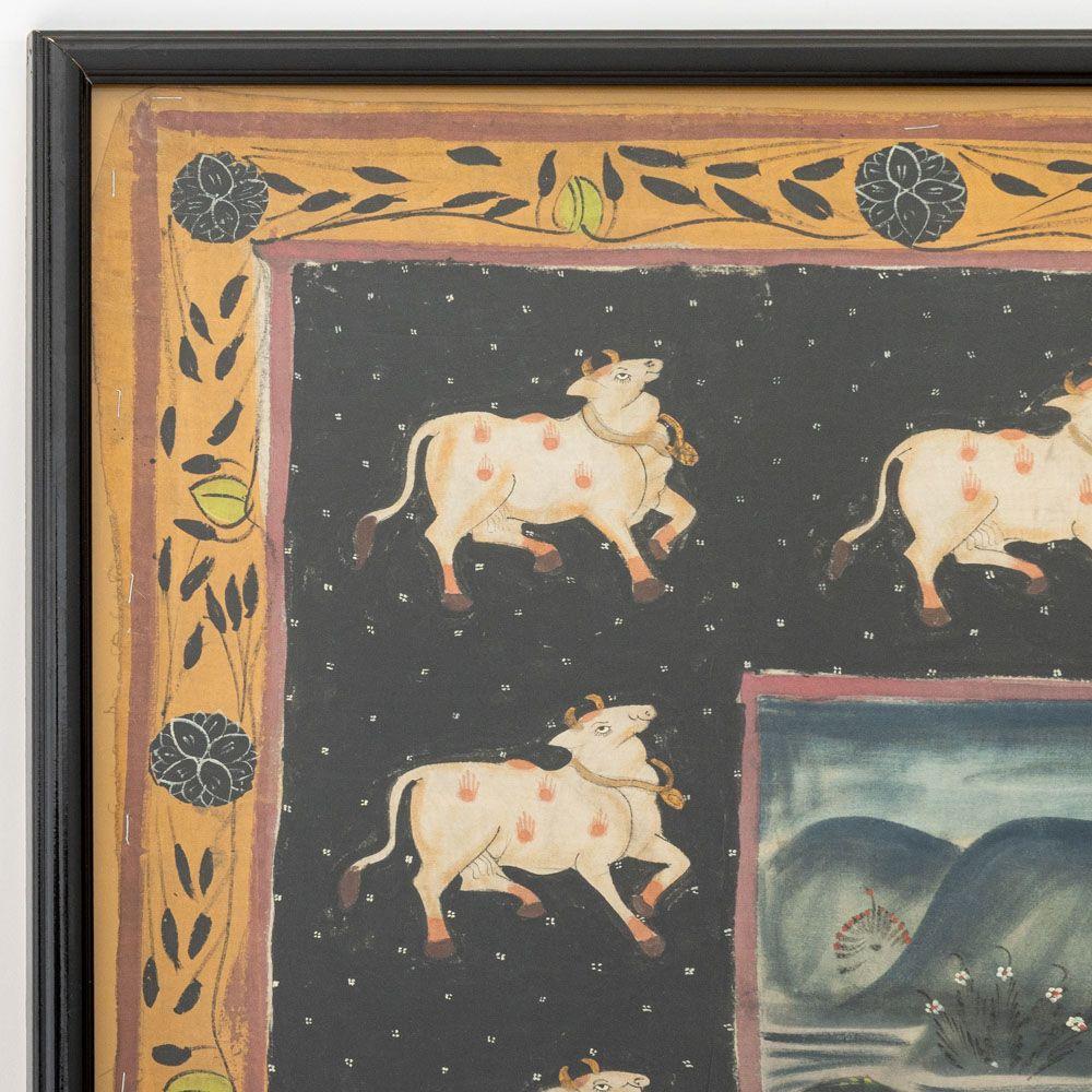 Indian School, Pichwai Painting, 19th century, gouache on cloth, depicting the Hindu god Krishna, sacred cows, consorts, and attendants within a scrolling foliate border, black frame. Image: 43