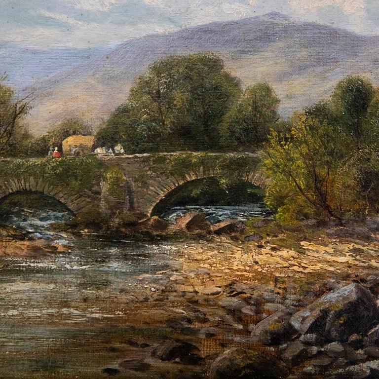 Un delicioso estudio al óleo que representa figuras con un carro de heno cruzando un puente de piedra. En primer plano, unas figuras observan a los transeúntes desde la orilla del río. Firmado en la parte inferior derecha. Bien presentado en un