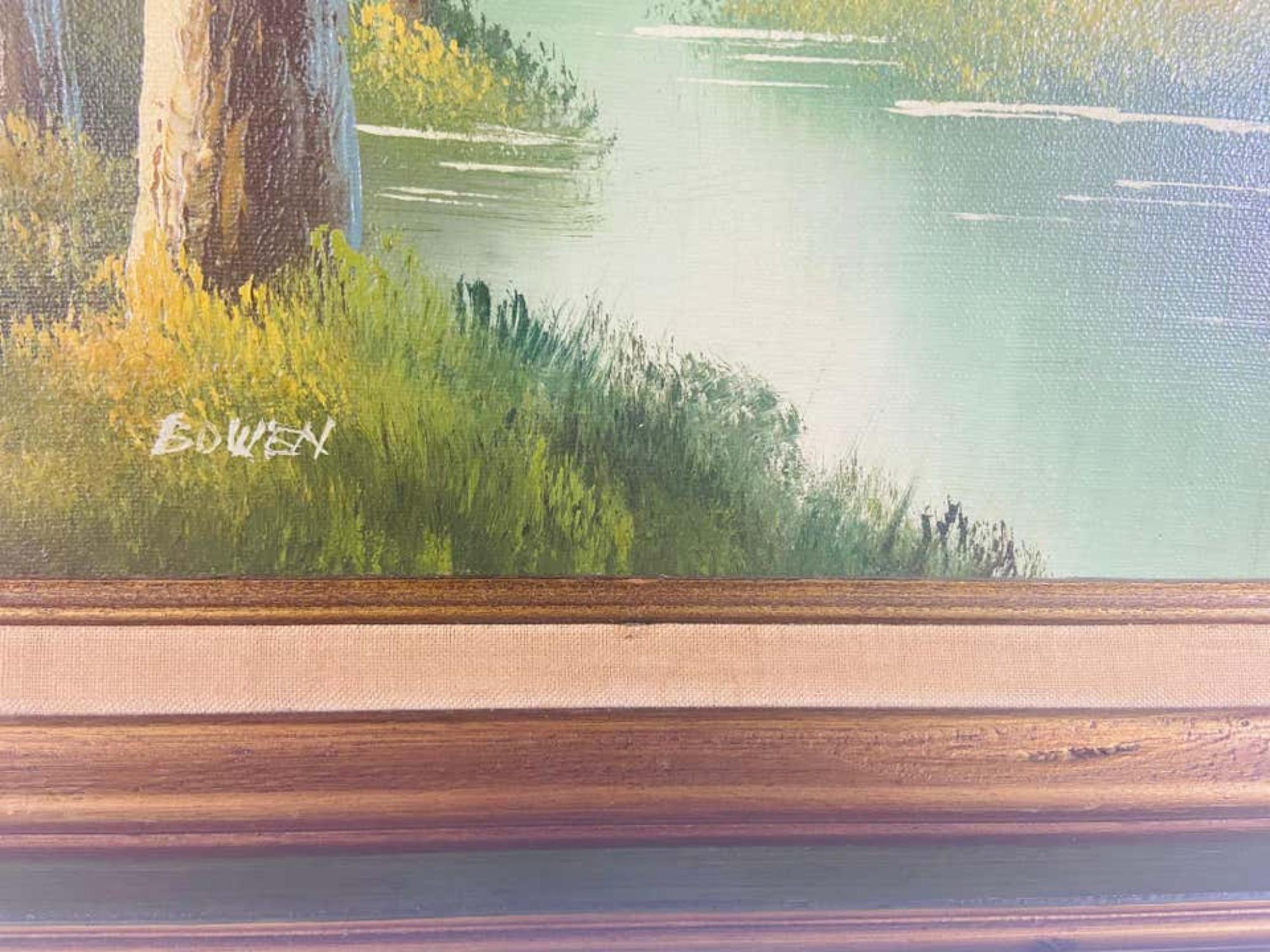 An oil on canvas landscape painting featuring a peaceful scene of a river in the middle of the wood. The painting is made in green color tone. The art work is finely framed in custom handmade wooden frame painted in dark green and gilt color. This