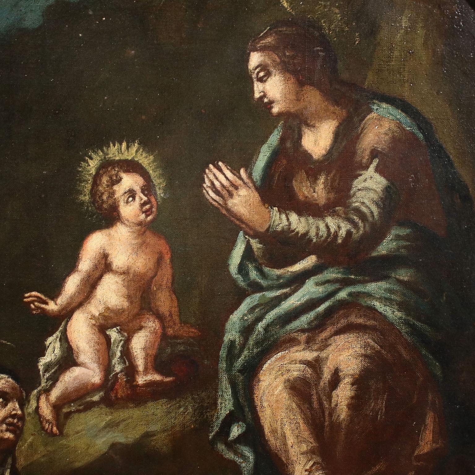 Oil painting on canvas. The scene proposes the adoration of the Child Jesus, placed in the center at the top, by some great saints, first of all by Mother Mary who is in a contemplative attitude of the Son seated like Him on a cloud; further down