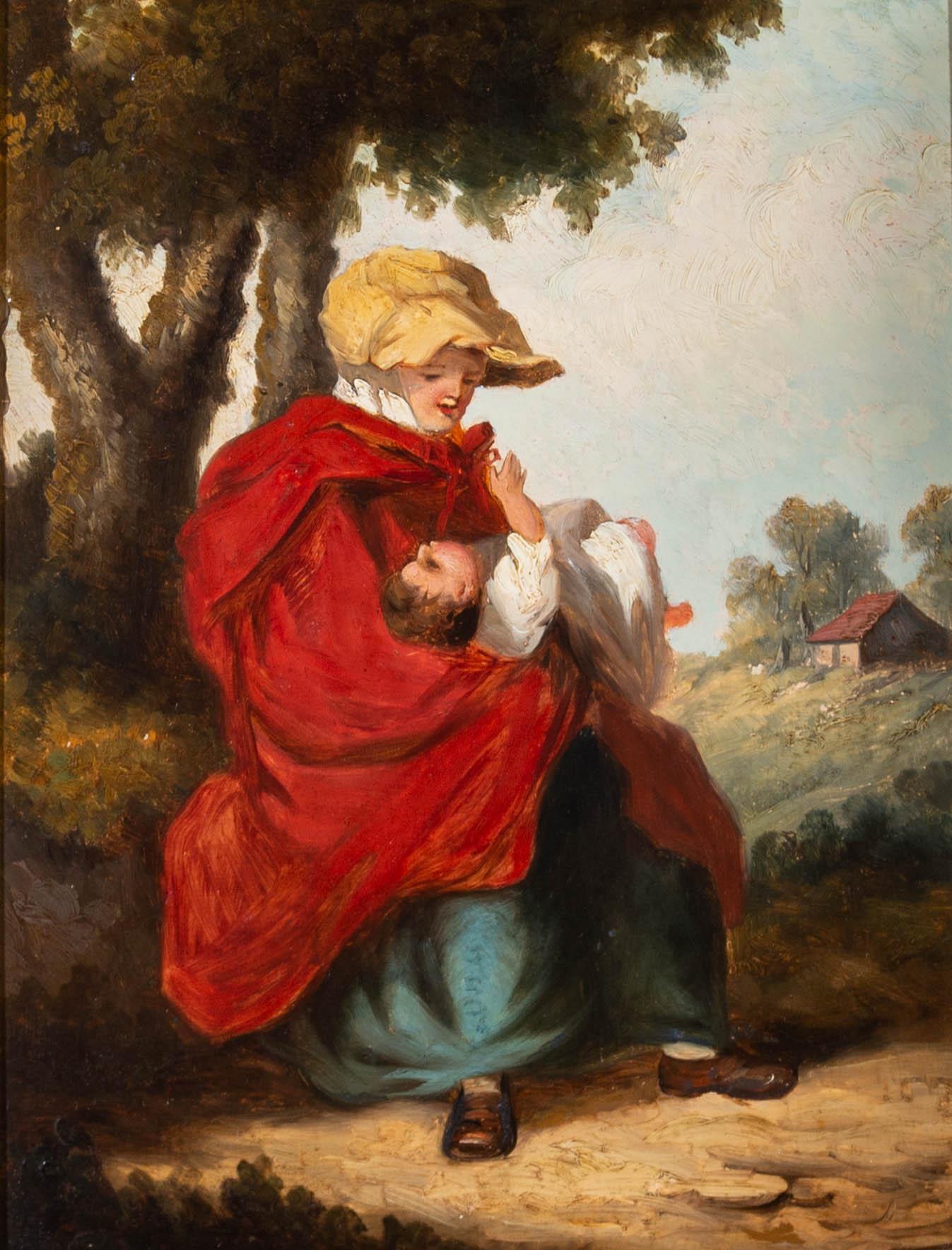 A charming Victorian oil, showing a woman in a red travelling cloak, holding a baby in her arms as the child reaches up to her face. The pair are sat at the side of a dusty path on a sunny day,. The painting is unsigned and presented in a handsome