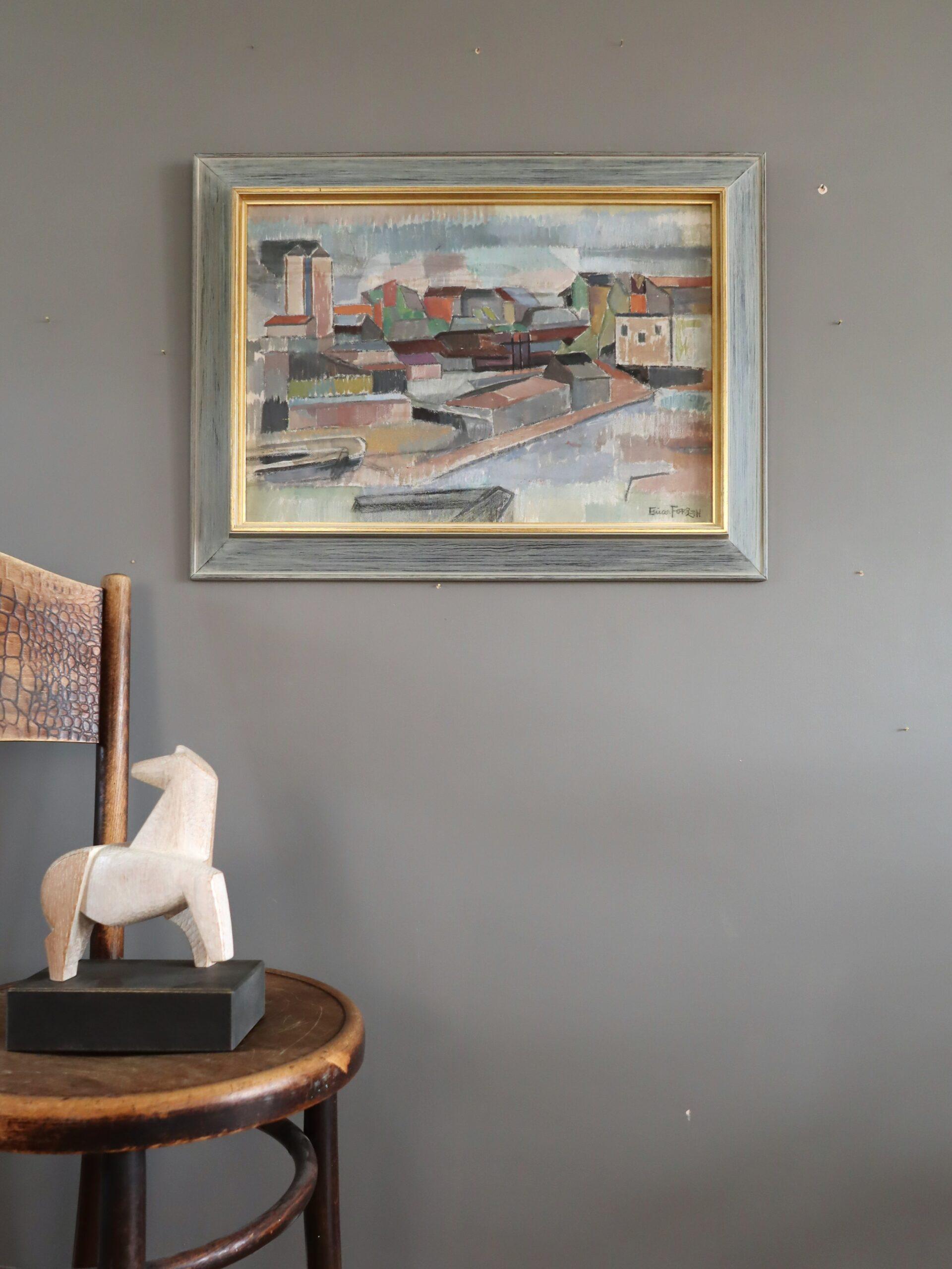 FRAGMENTS OF THE CITY
Size: 50 x 66.5 cm (including frame)
Oil on board

A captivating mid-century modernist painting that depicts a stylised urban landscape, characterised by a series of geometric forms representing rooftops, buildings, and water,