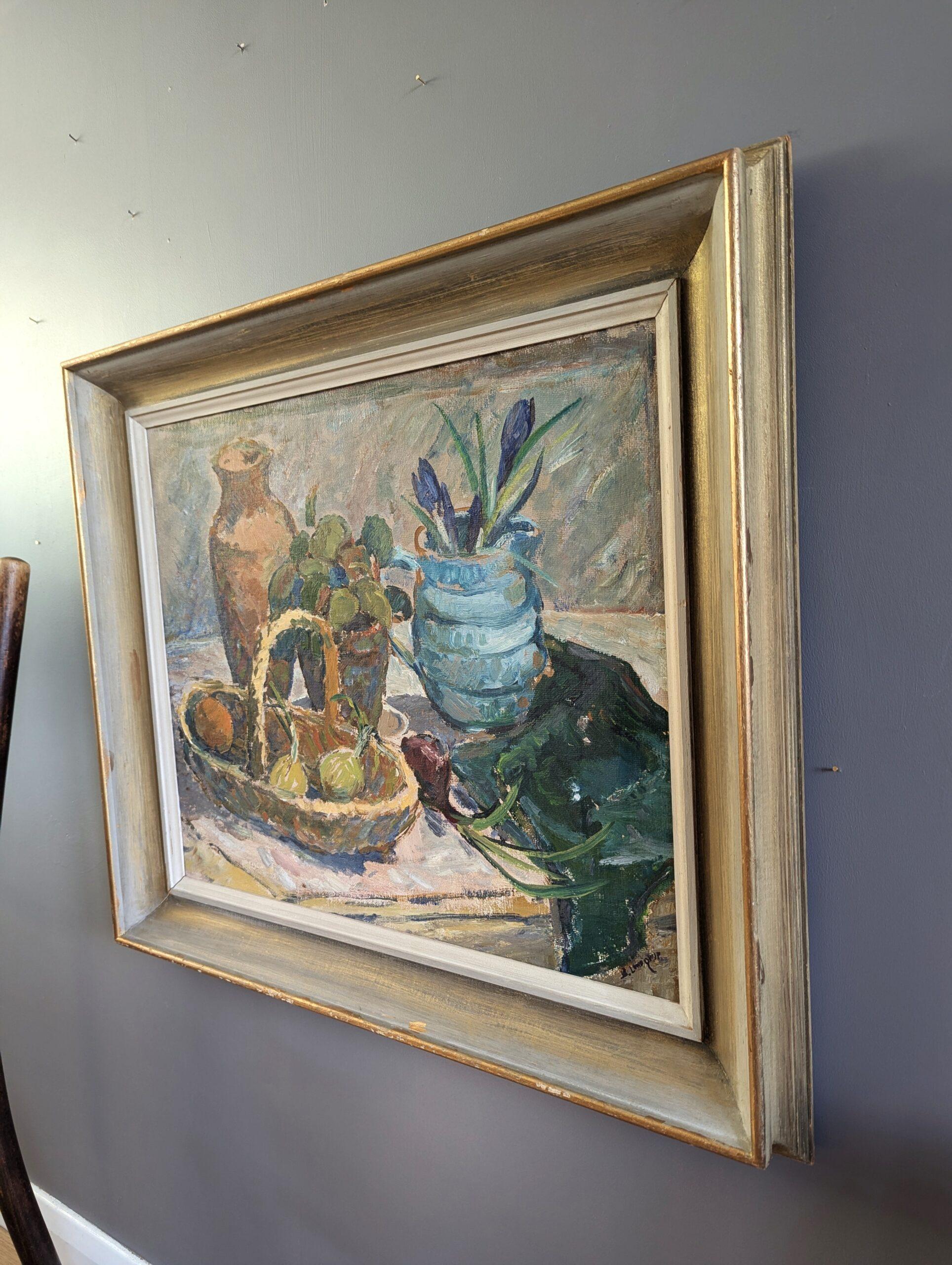 BASKET OF FRUIT
Size: 61 x 69.5 cm (including frame)
Oil on board

An expressive and charming mid century still life composition, executed in oil onto board.

The painting captures a carefully arranged tabletop composition featuring a woven basket
